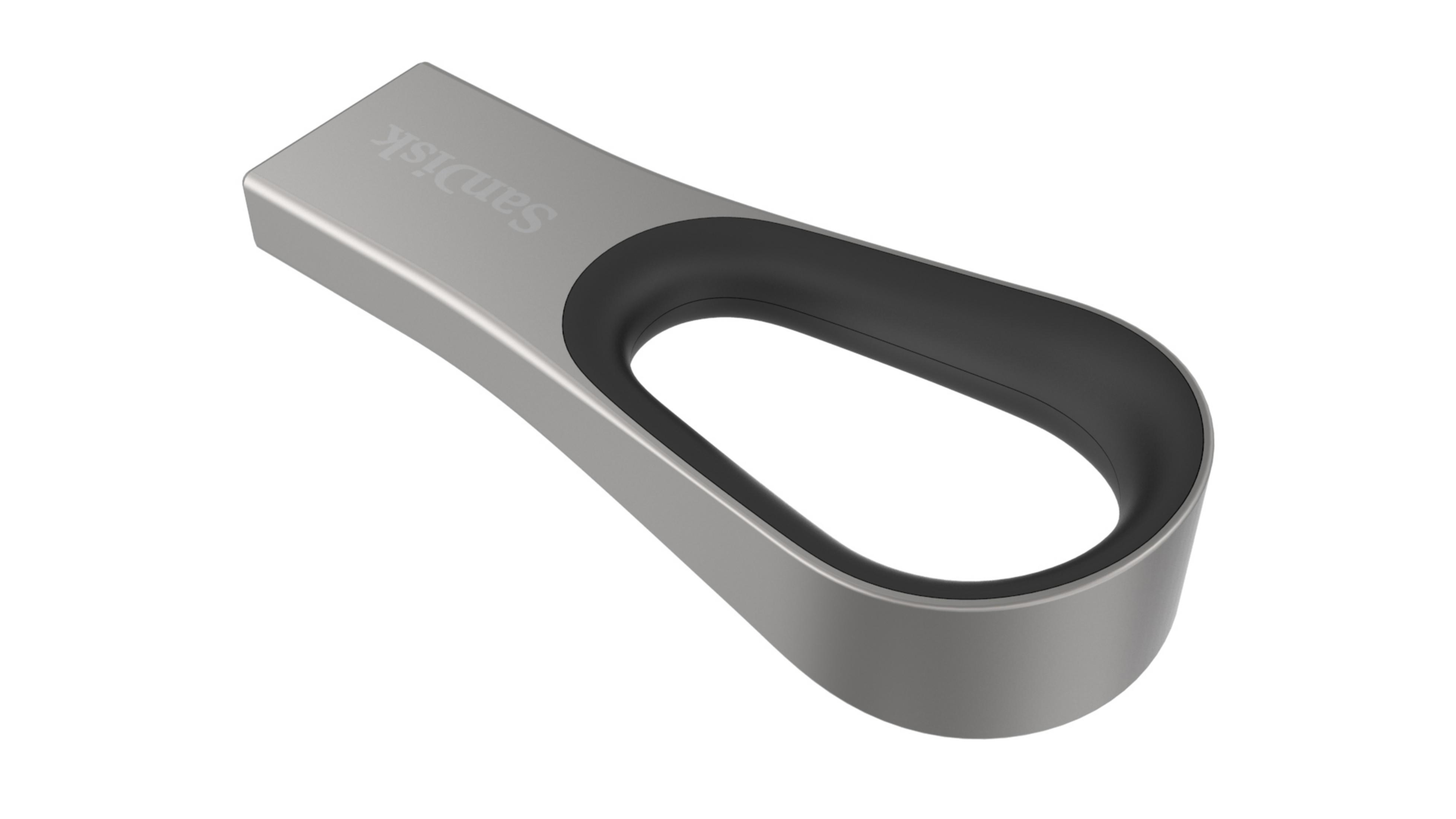 Un'unità USB argentata con un anello nero su una superficie bianca.