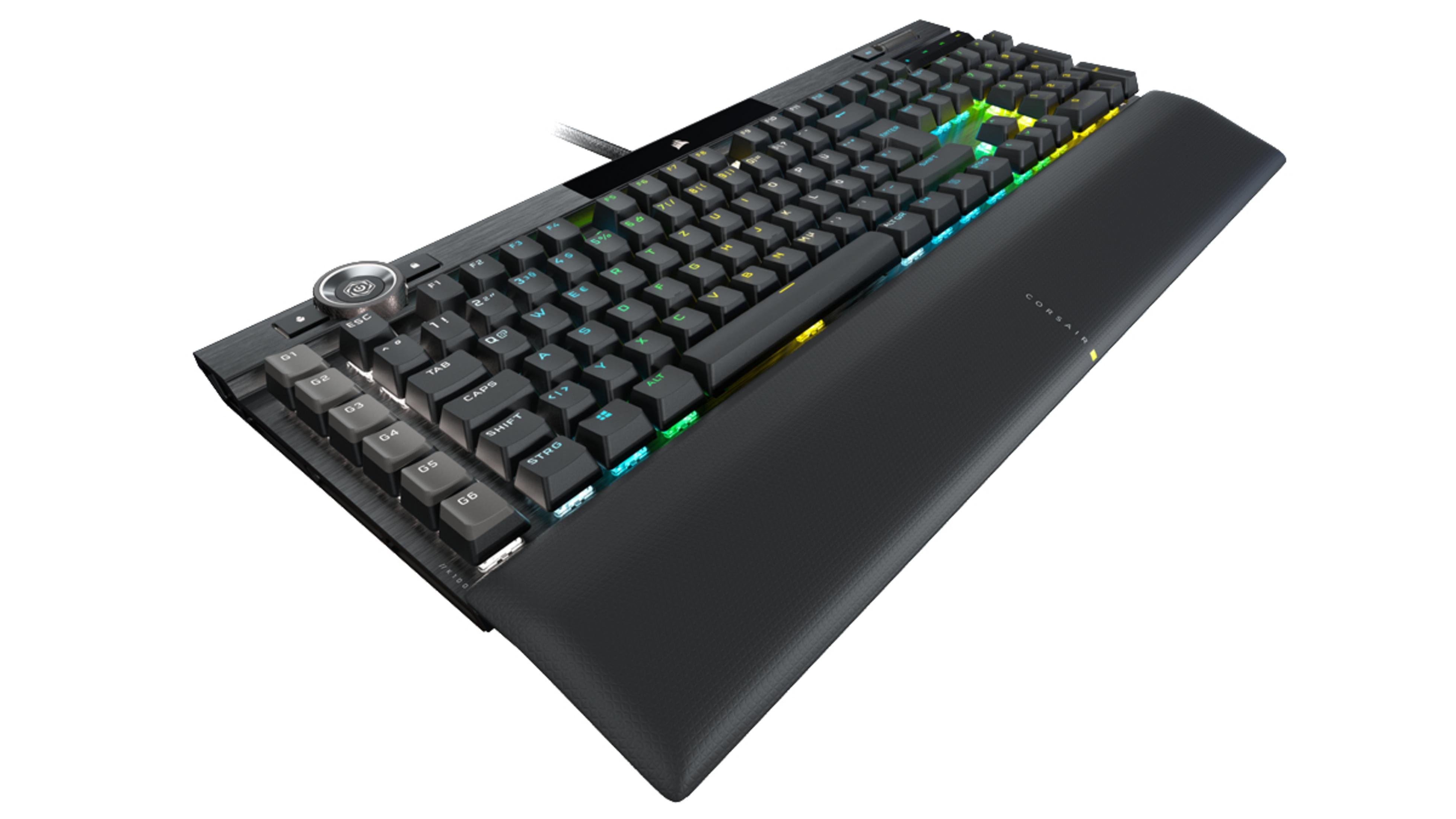 Teclado de ordenador negro y plateado con teclas retroiluminadas multicolores y reposamuñecas.