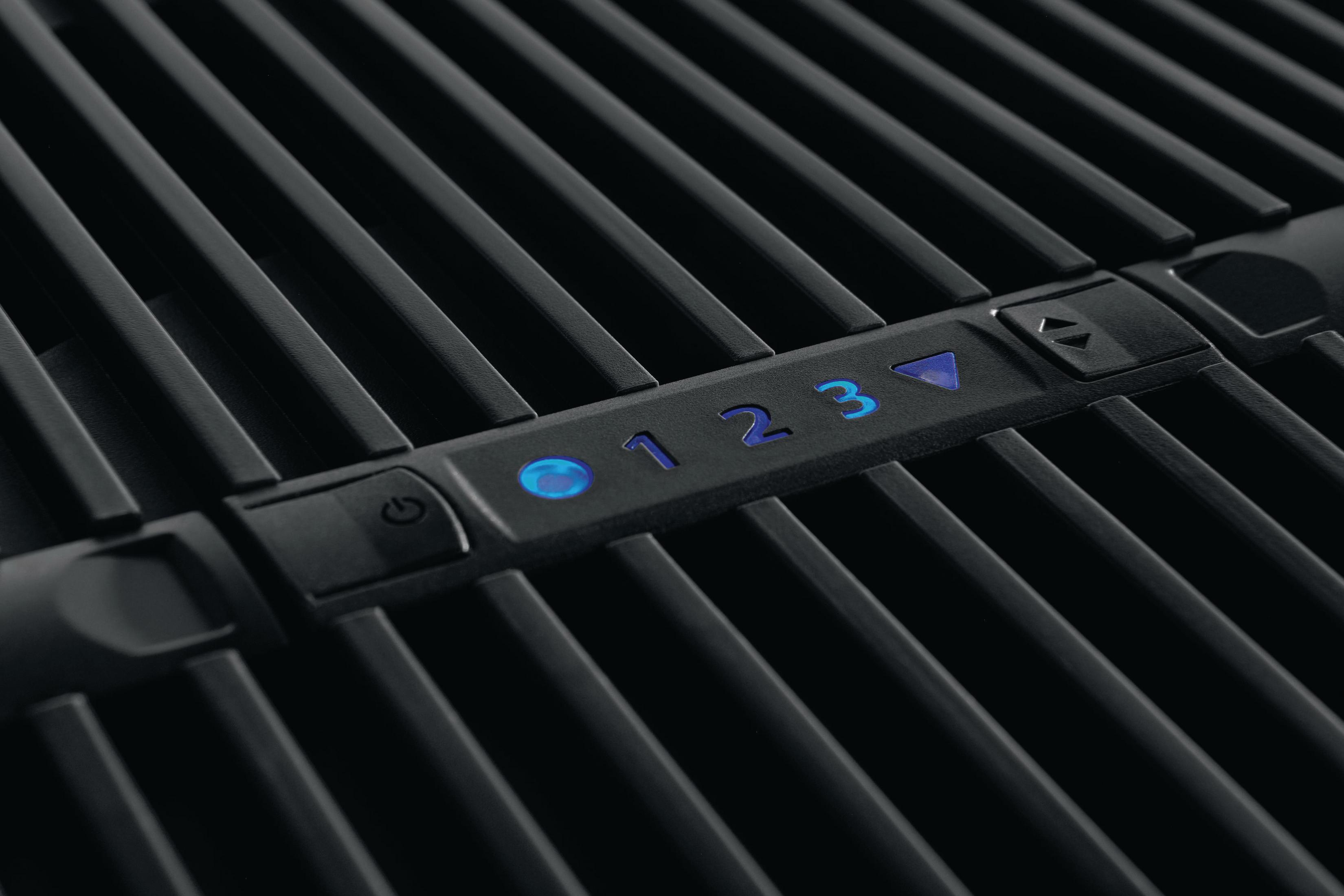 Nahaufnahme des Bedienfelds eines Grills mit Zahlen und blauen Lichtern.