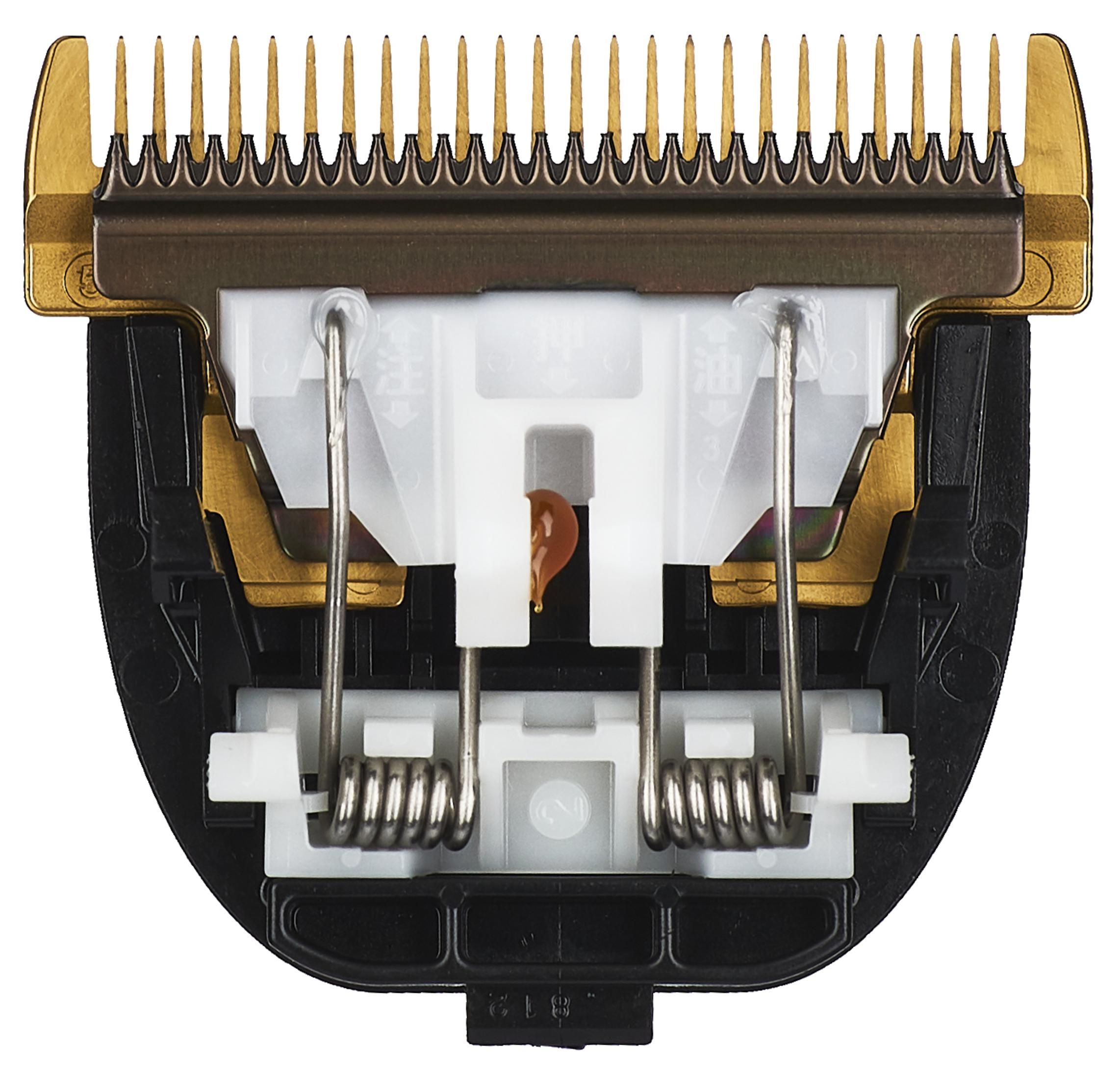 Nahaufnahme einer Haarschneidemaschinenklinge. Goldene Zähne, silberne Federn und weißes Kunststoffgehäuse.