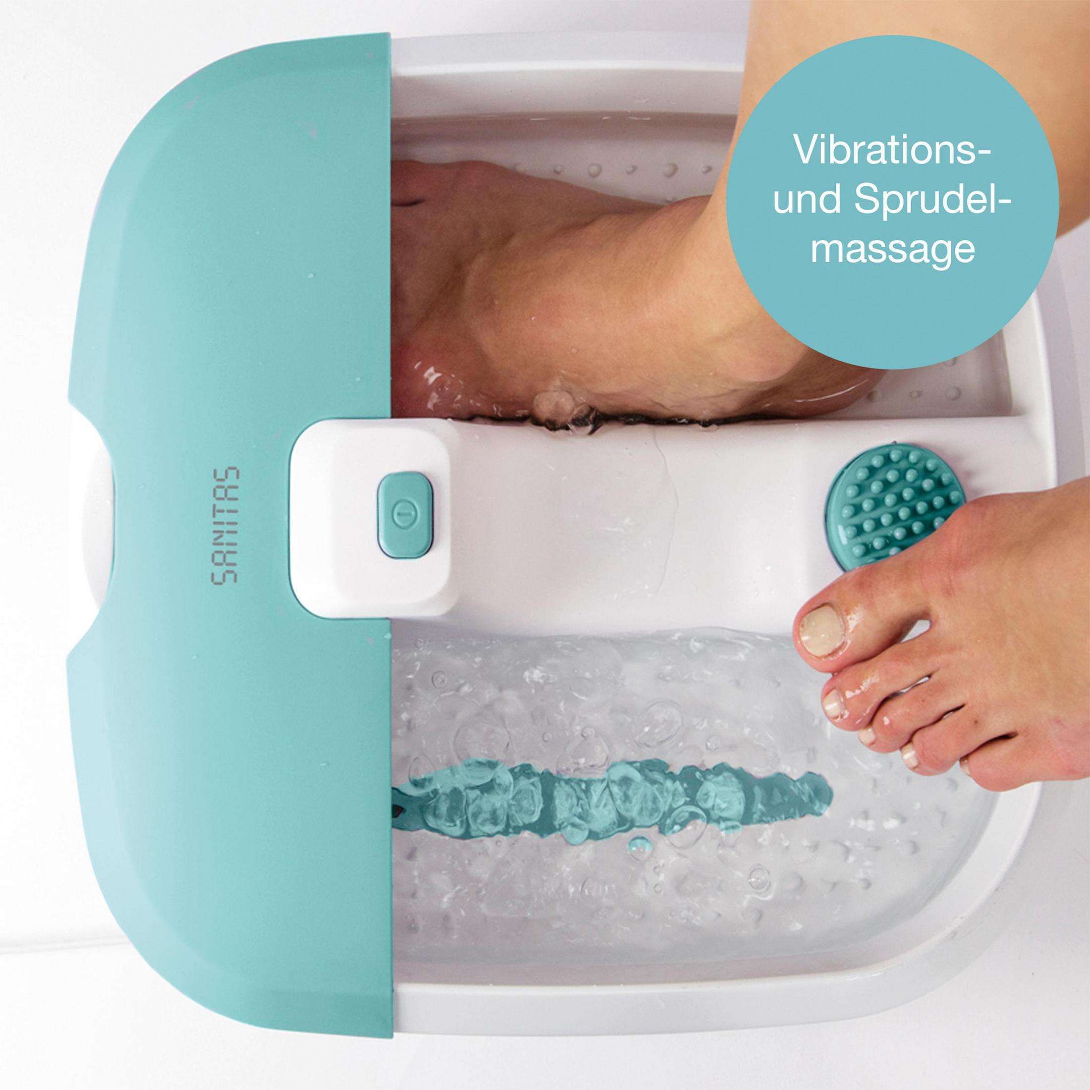 Pieds dans un bain de pieds, avec des bulles. Le texte "Vibrations-und Sprudelmassage" est affiché.