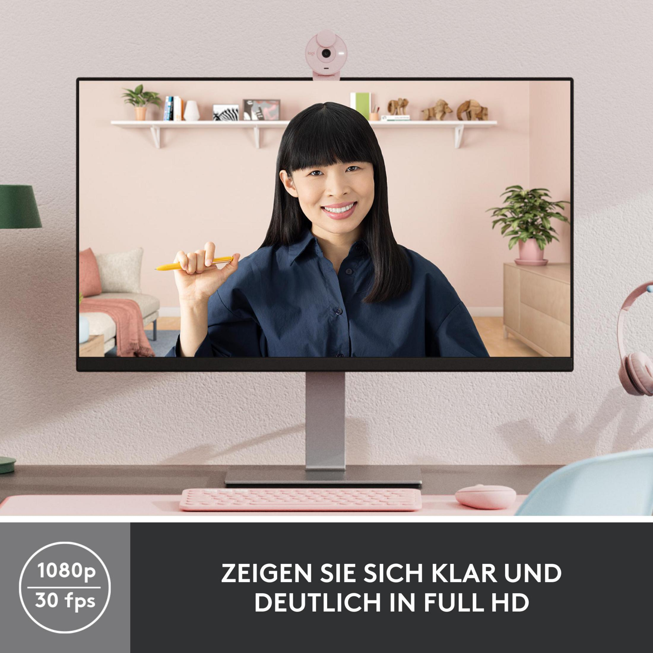 Eine Frau hält einen Stift auf einem Monitor, mit einer Webcam über dem Bildschirm.