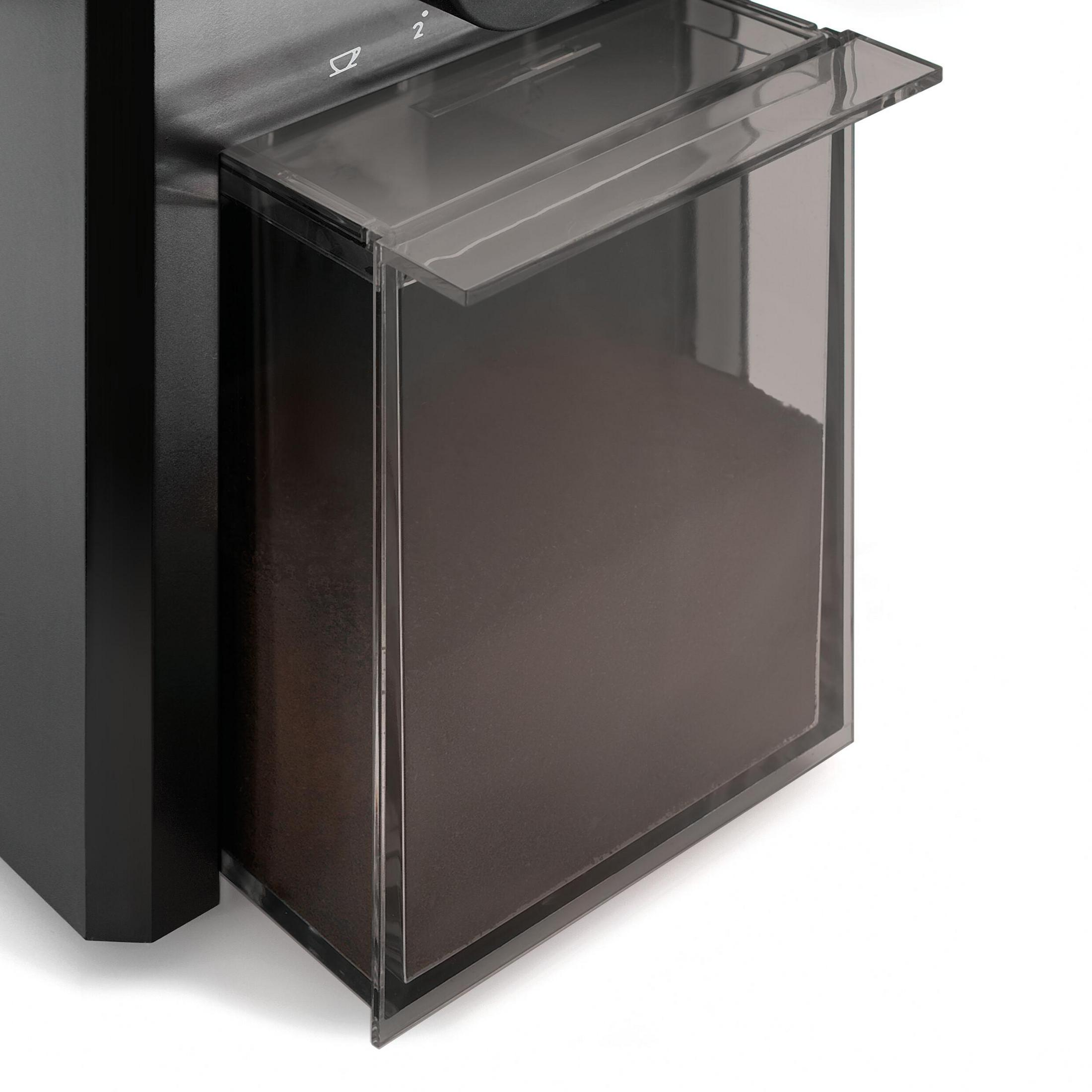 Primer plano del recipiente transparente de granos de un molinillo de café. Se ve café molido oscuro.