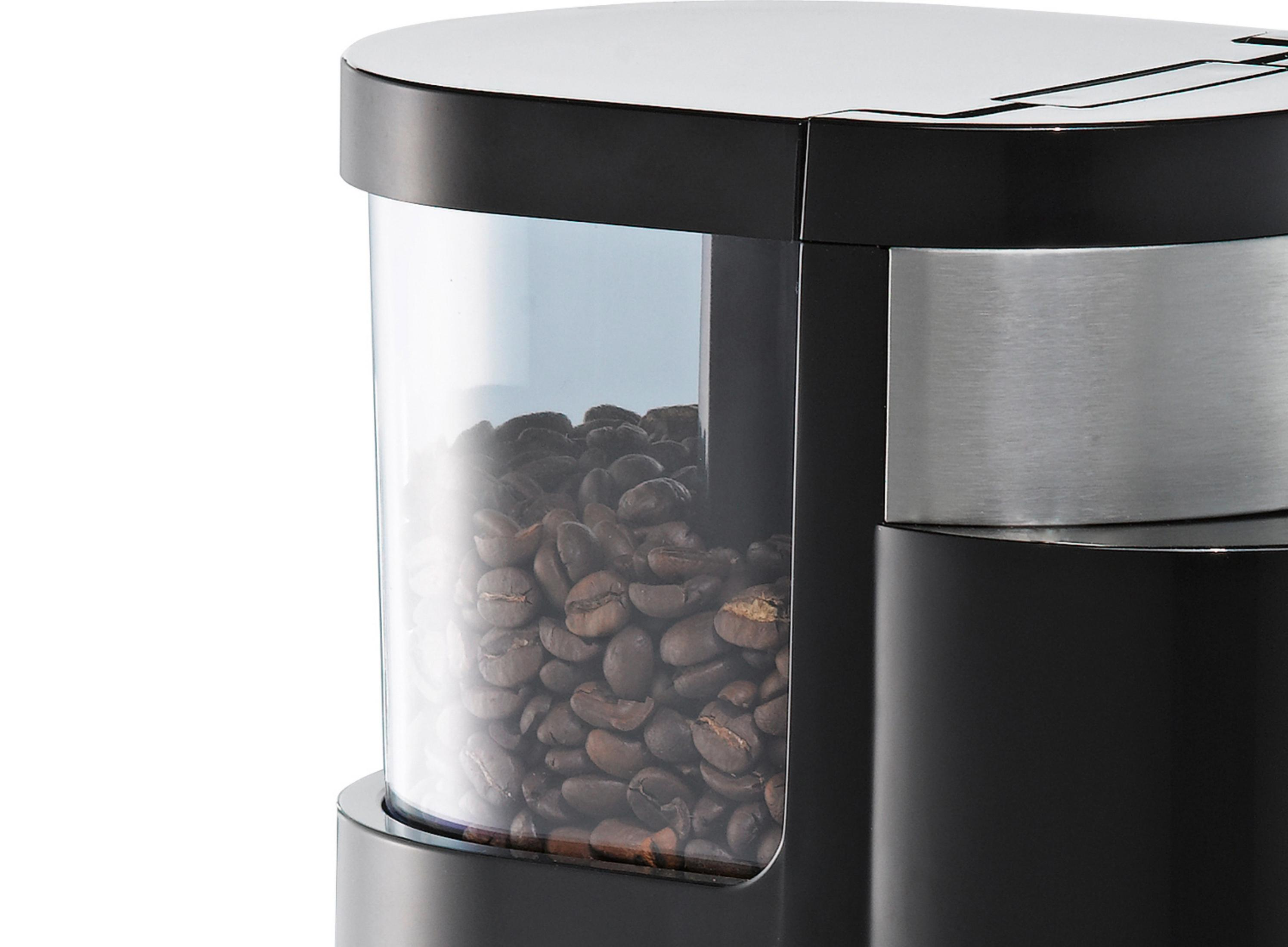 Zbliżenie pojemnika na ziarna w ekspresie do kawy, wypełnionego ziarnami kawy.