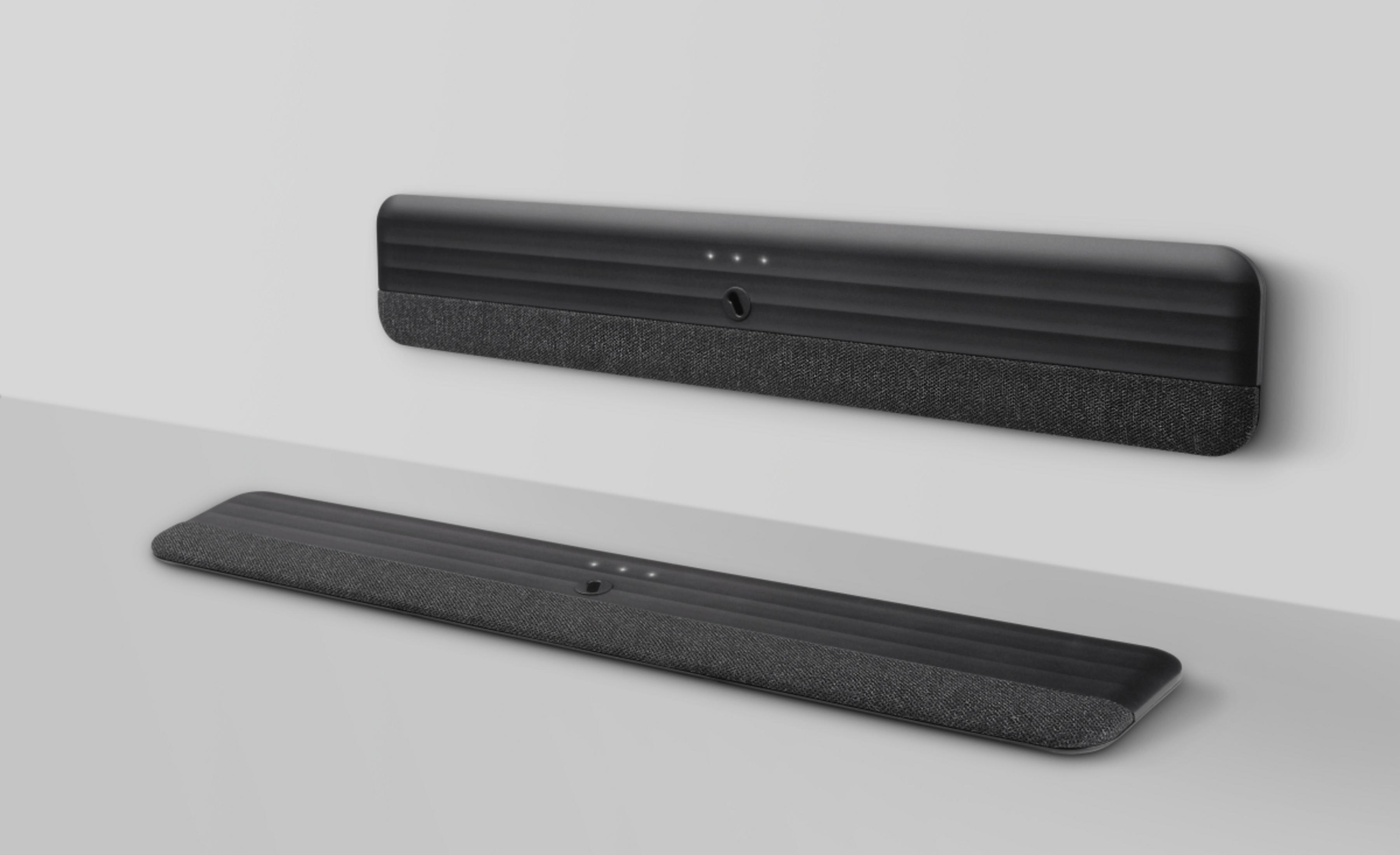 Dwa czarne soundbary, jeden zamontowany na ścianie, a drugi na powierzchni, oba z przodem pokrytym tkaniną.