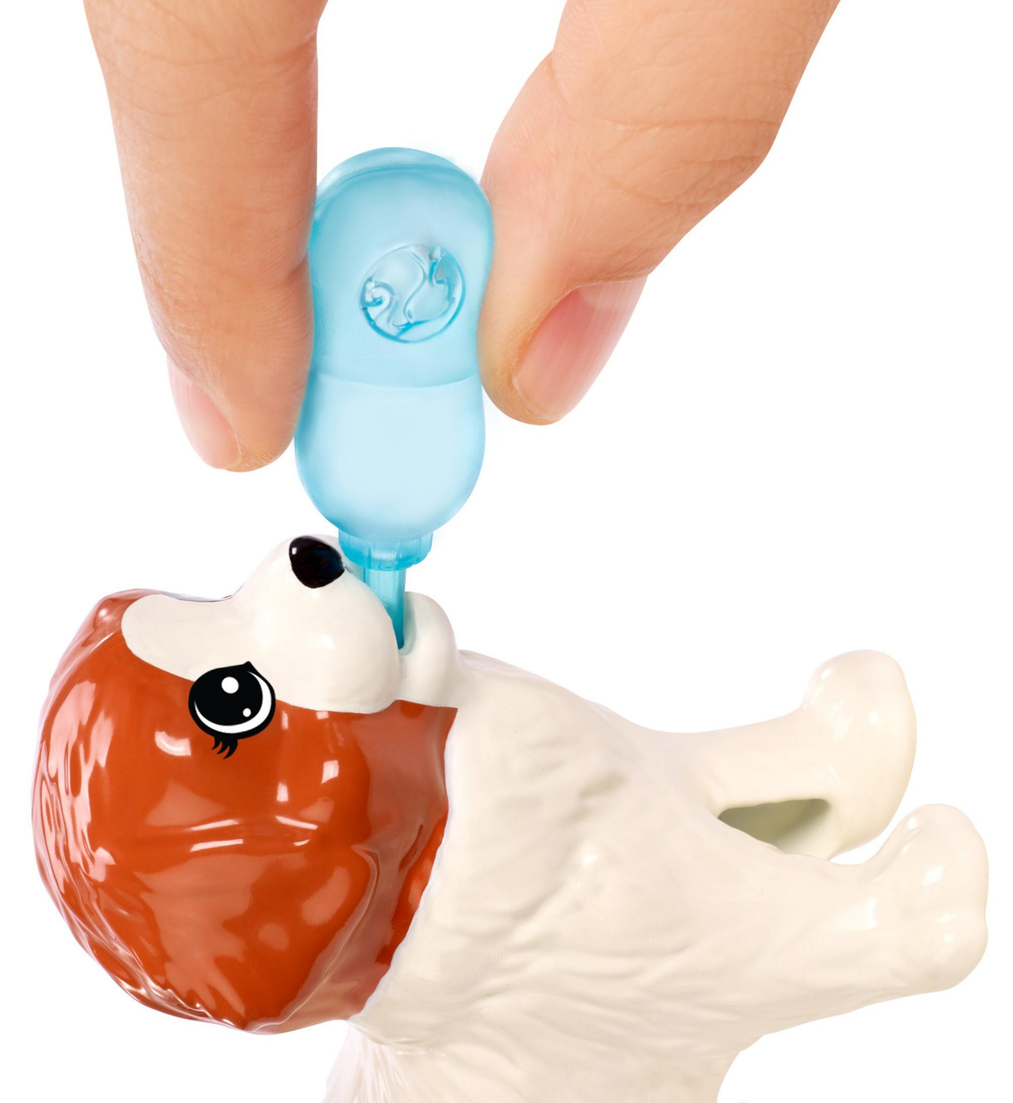 Hand hält blaue Wasserflasche, um einen Spielzeughund zu füttern. Der Hund ist braun und weiß.