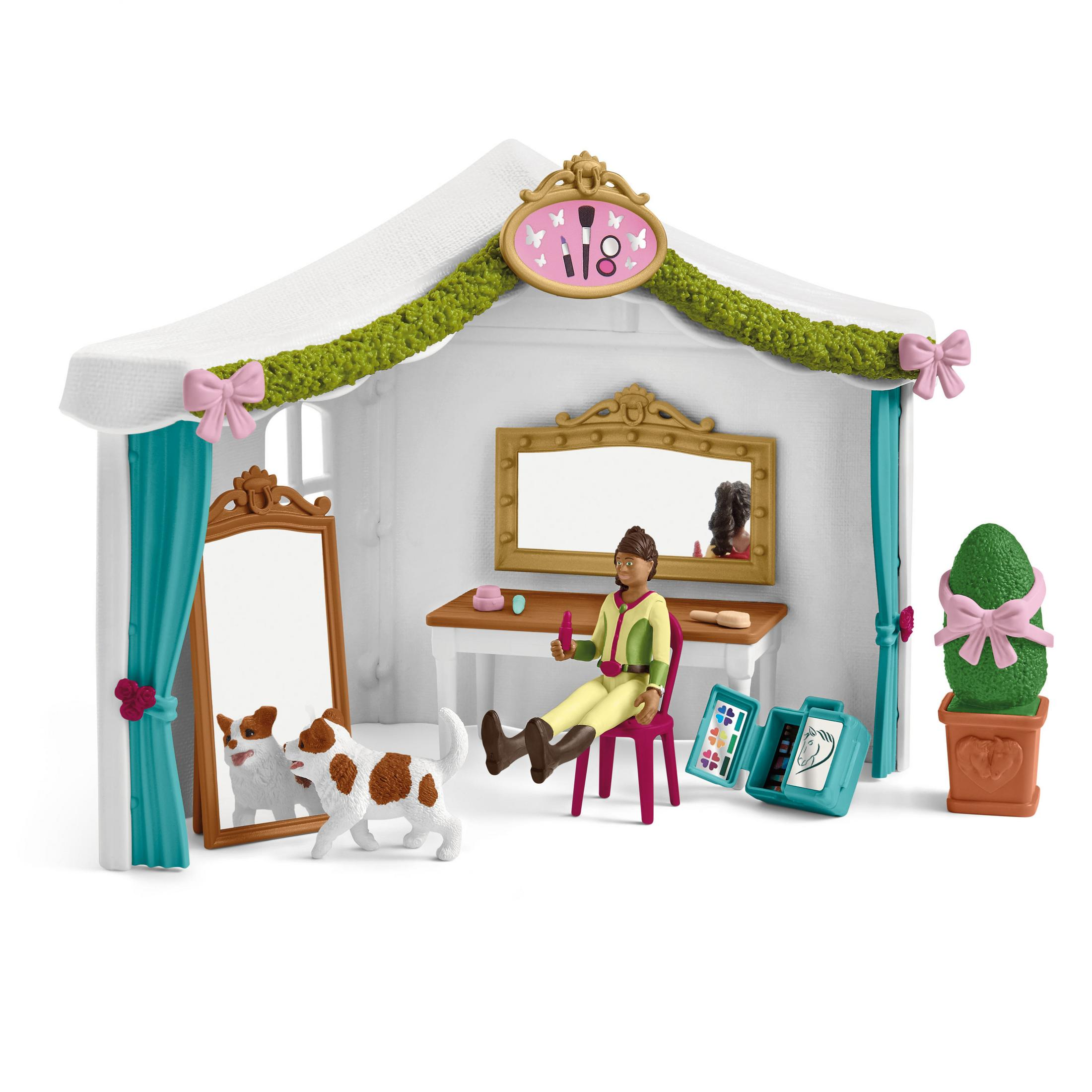 Ein Schönheitssalon-Spielset mit einer Frau, einem Hund und Zubehör. Weißer Hintergrund.