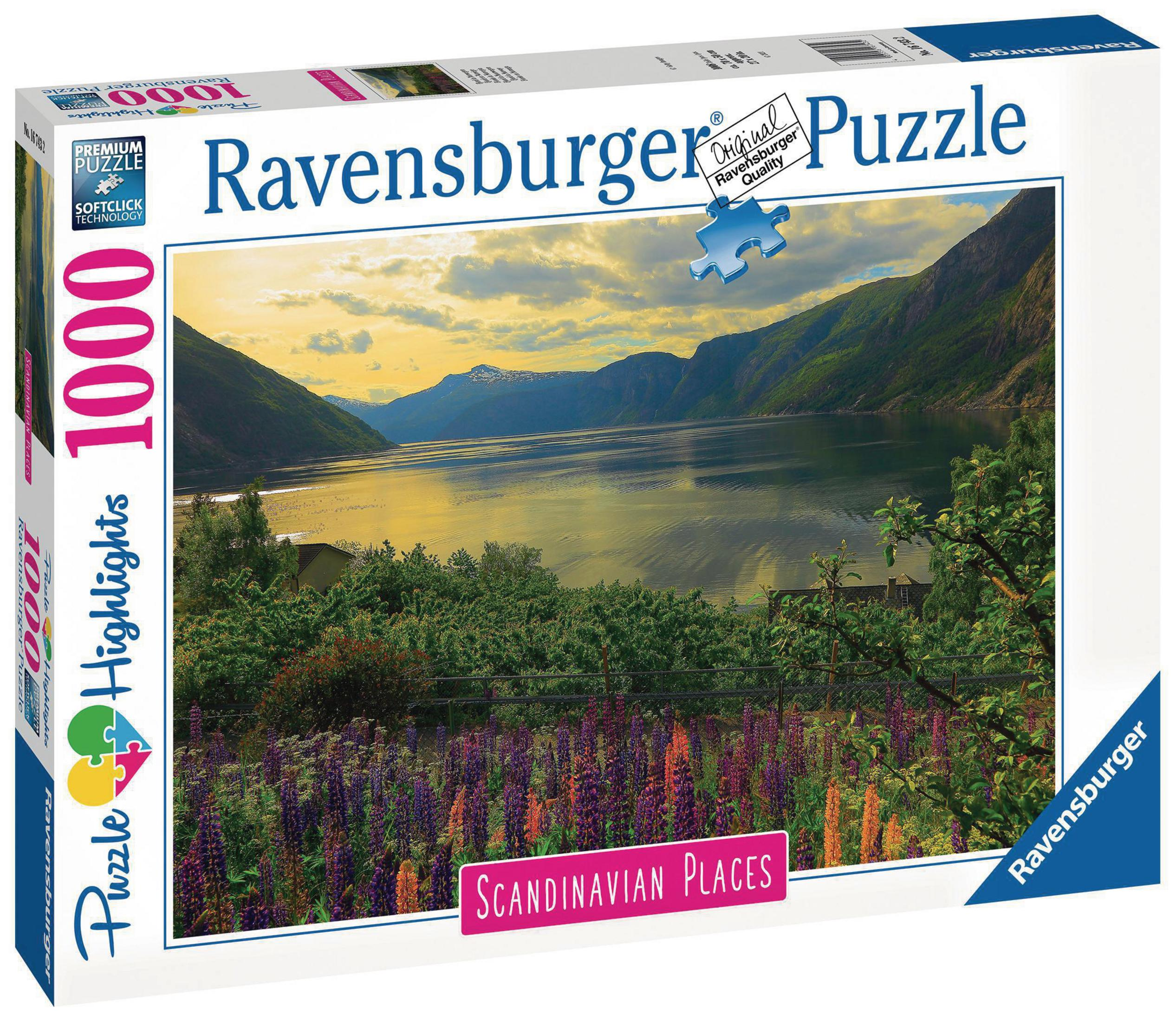 Pudełko puzzli Ravensburger, krajobraz jeziora i gór z kolorowymi kwiatami.