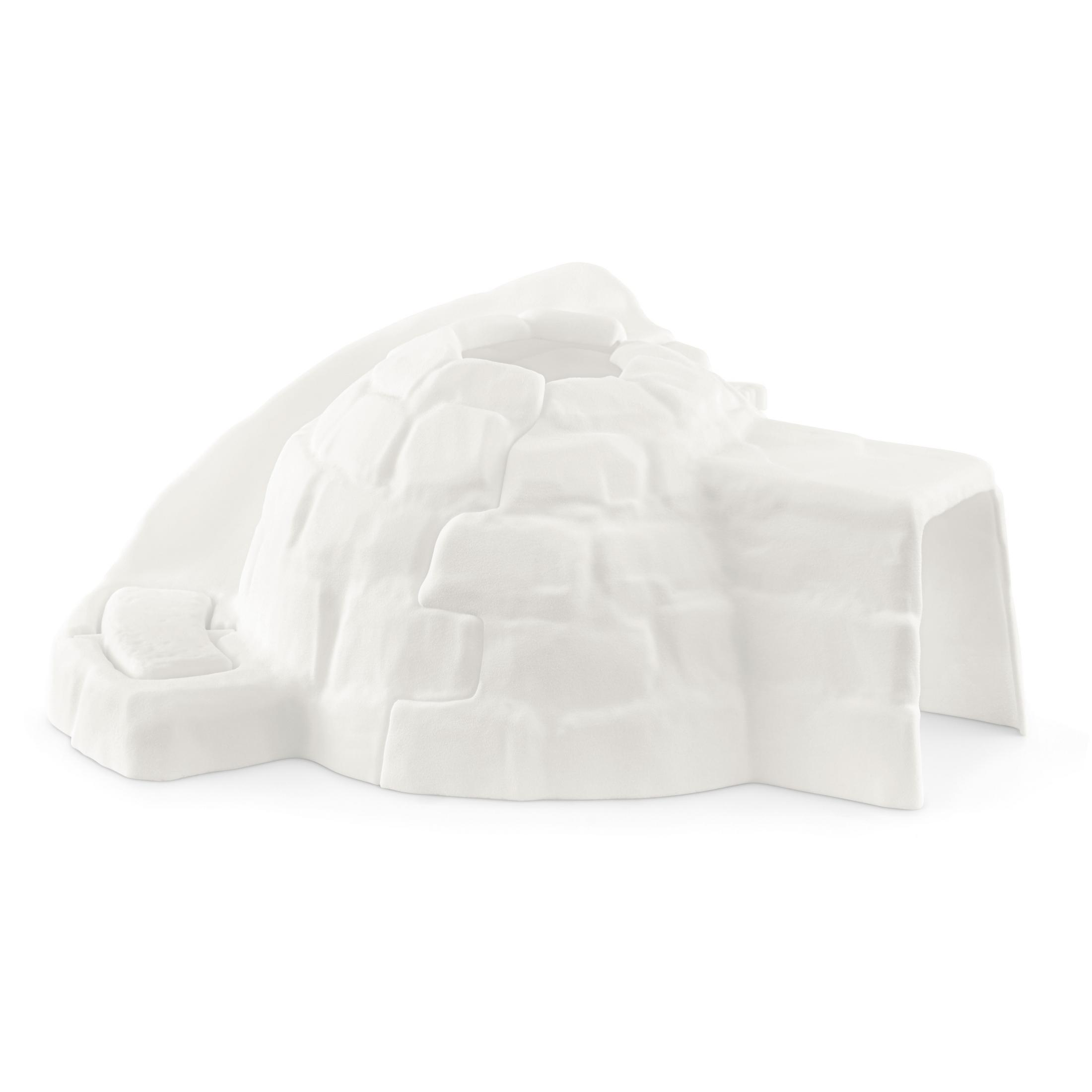 Igloo jouet blanc avec un dessus arrondi et une entrée. L'igloo est fait de blocs rectangulaires.