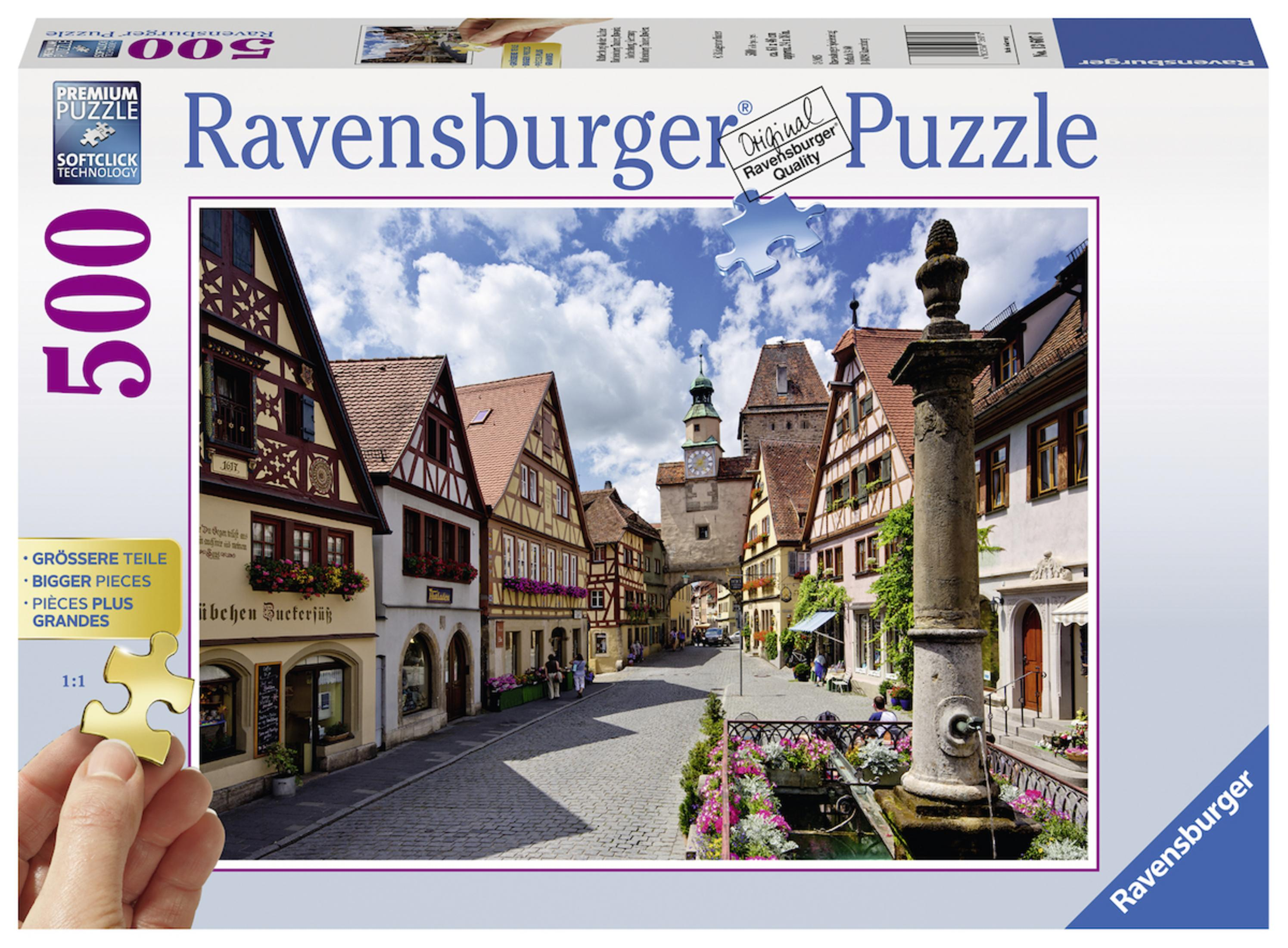 Ravensburger 500-teilige Puzzlebox. Es zeigt eine Straßenszene mit Gebäuden und einem Brunnen.