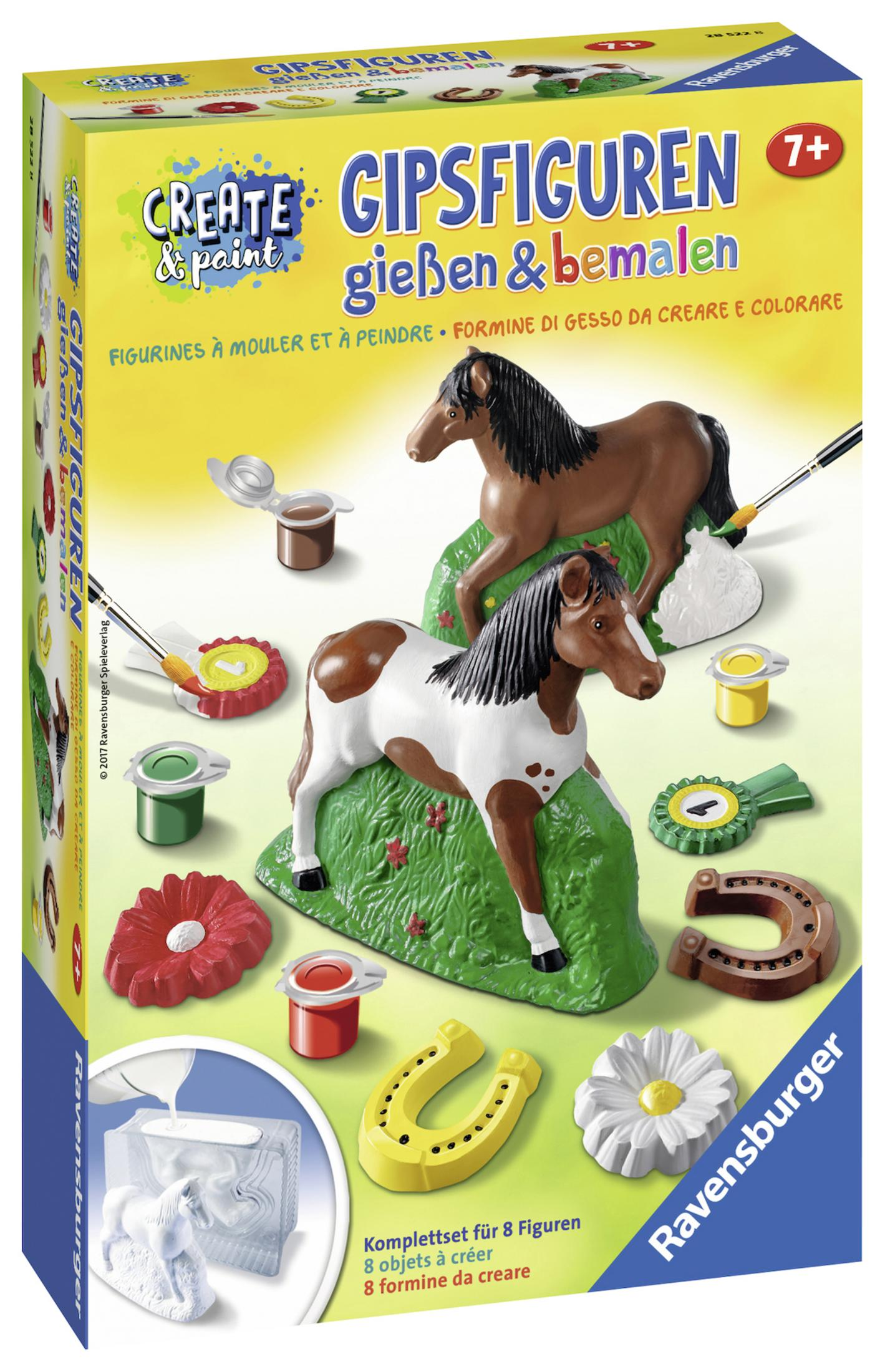 Eine Box mit einem Gemälde von Pferden. Die Box hat Farbtöpfe, Pinsel und Pferdefiguren darauf.