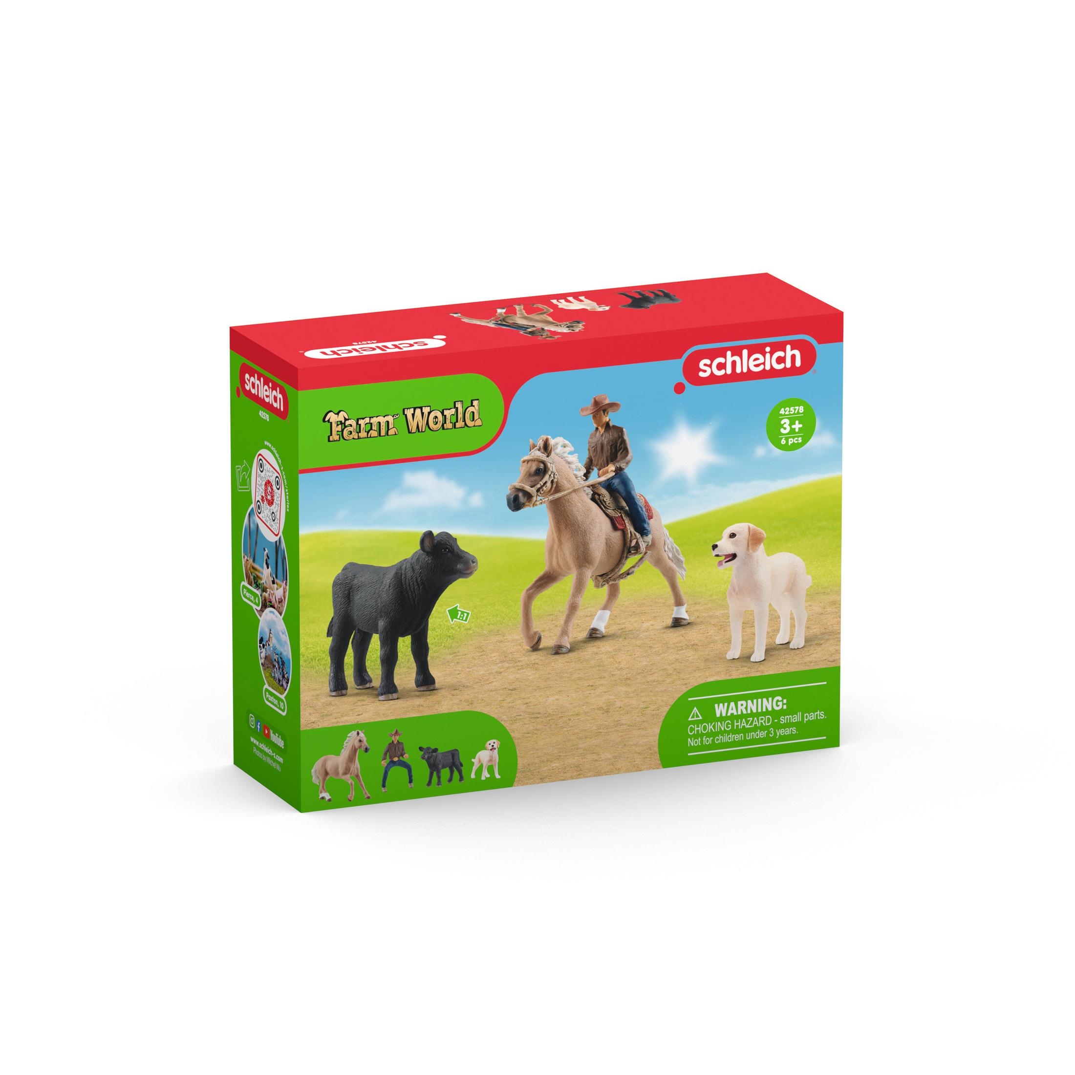 Eine Spielzeugbox zeigt einen Pferdereiter, ein schwarzes Kalb und einen Hund. Die Box ist für ein Bauernhof-Set.