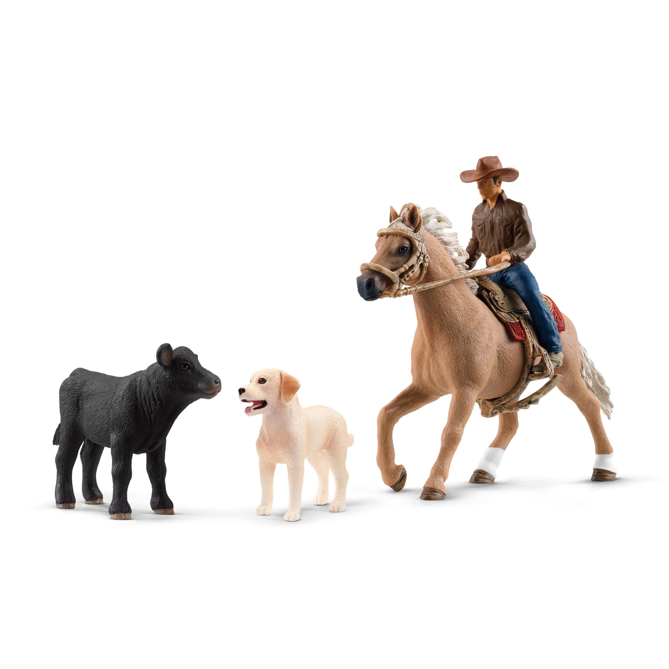 Spielfiguren eines Cowboys auf einem Pferd, eines schwarzen Kalbes und eines Hundes. Weißer Hintergrund.