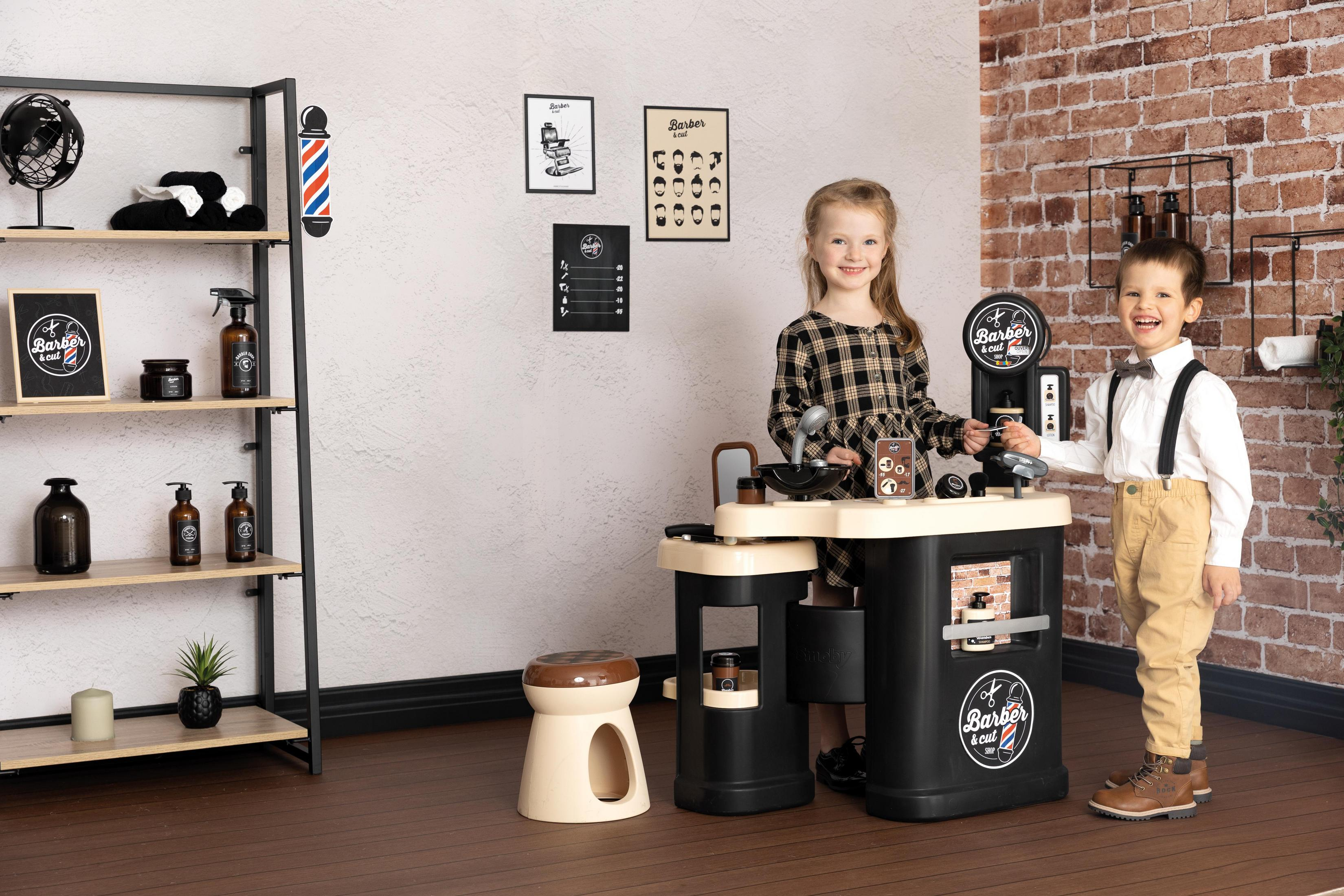 Zwei Kinder spielen mit einem Spielzeug-Friseursalon, mit einer Vielzahl von Zubehör.