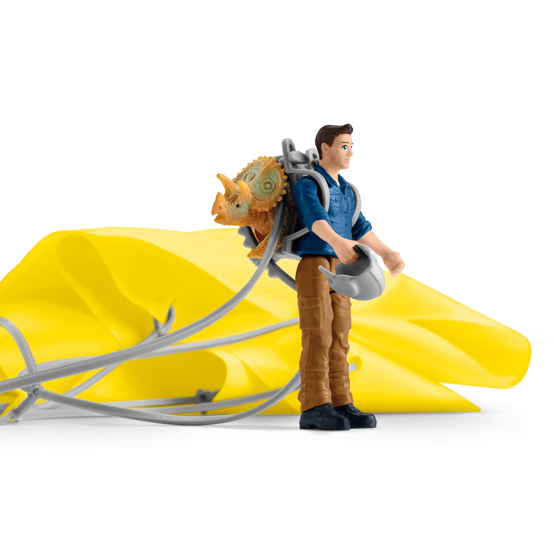 A man with a backpack carrying a dinosaur toy and a yellow cloth.