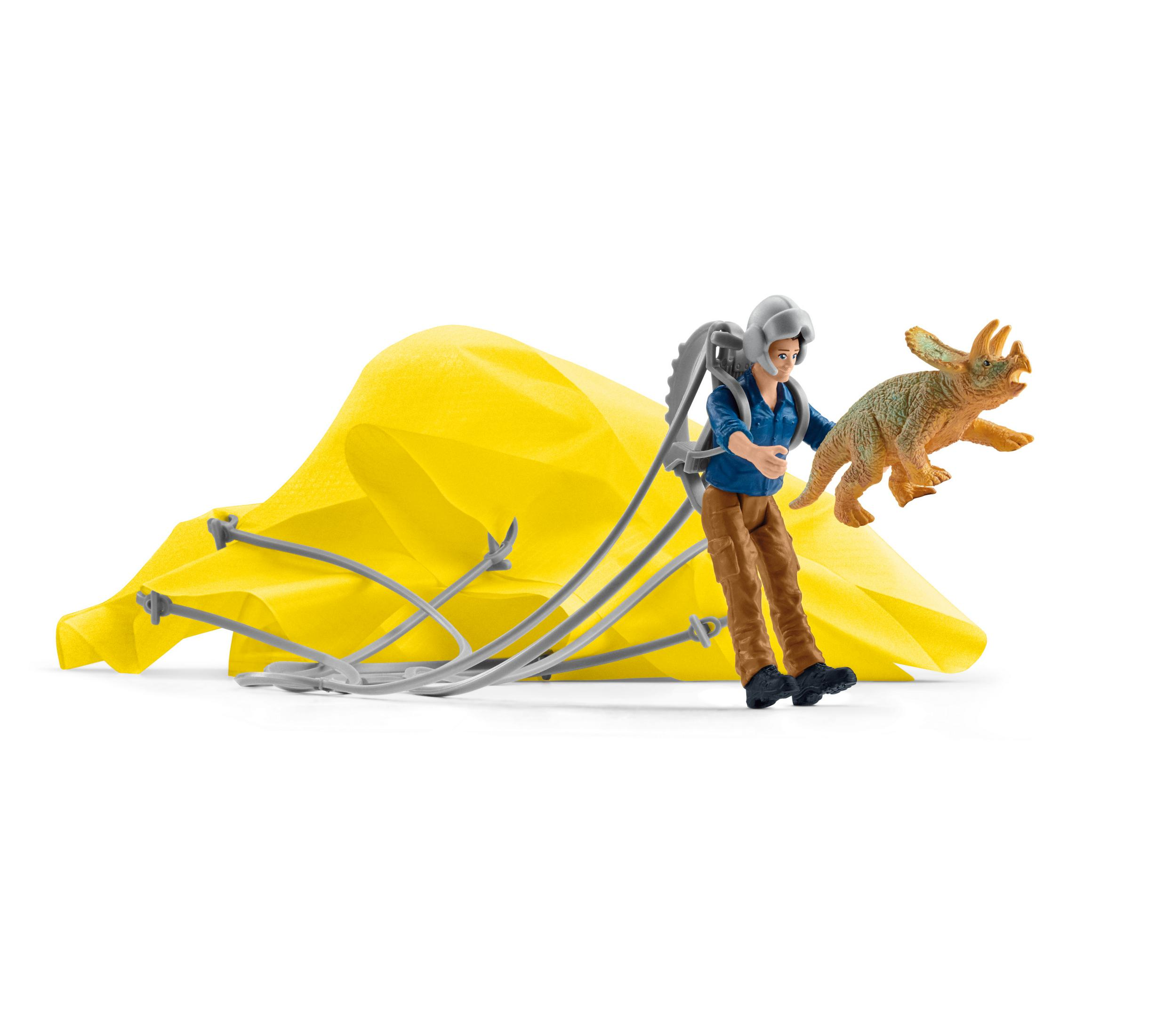 A toy figure with a jetpack is chasing a toy dinosaur. A yellow parachute is spread out in the background.