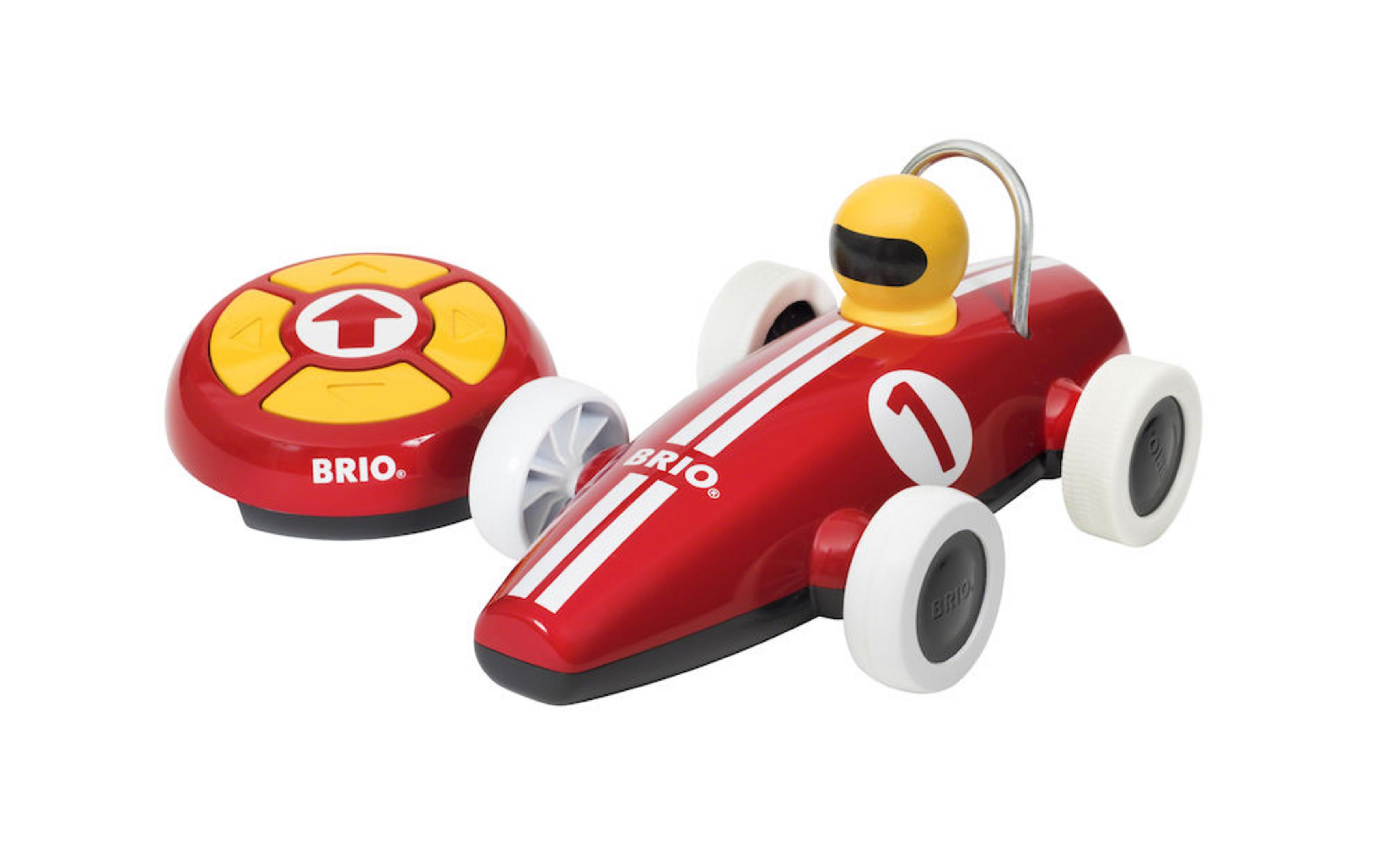 Ein rotes Spielzeug-Rennauto mit einem gelben Fahrer und einer Fernbedienung.
