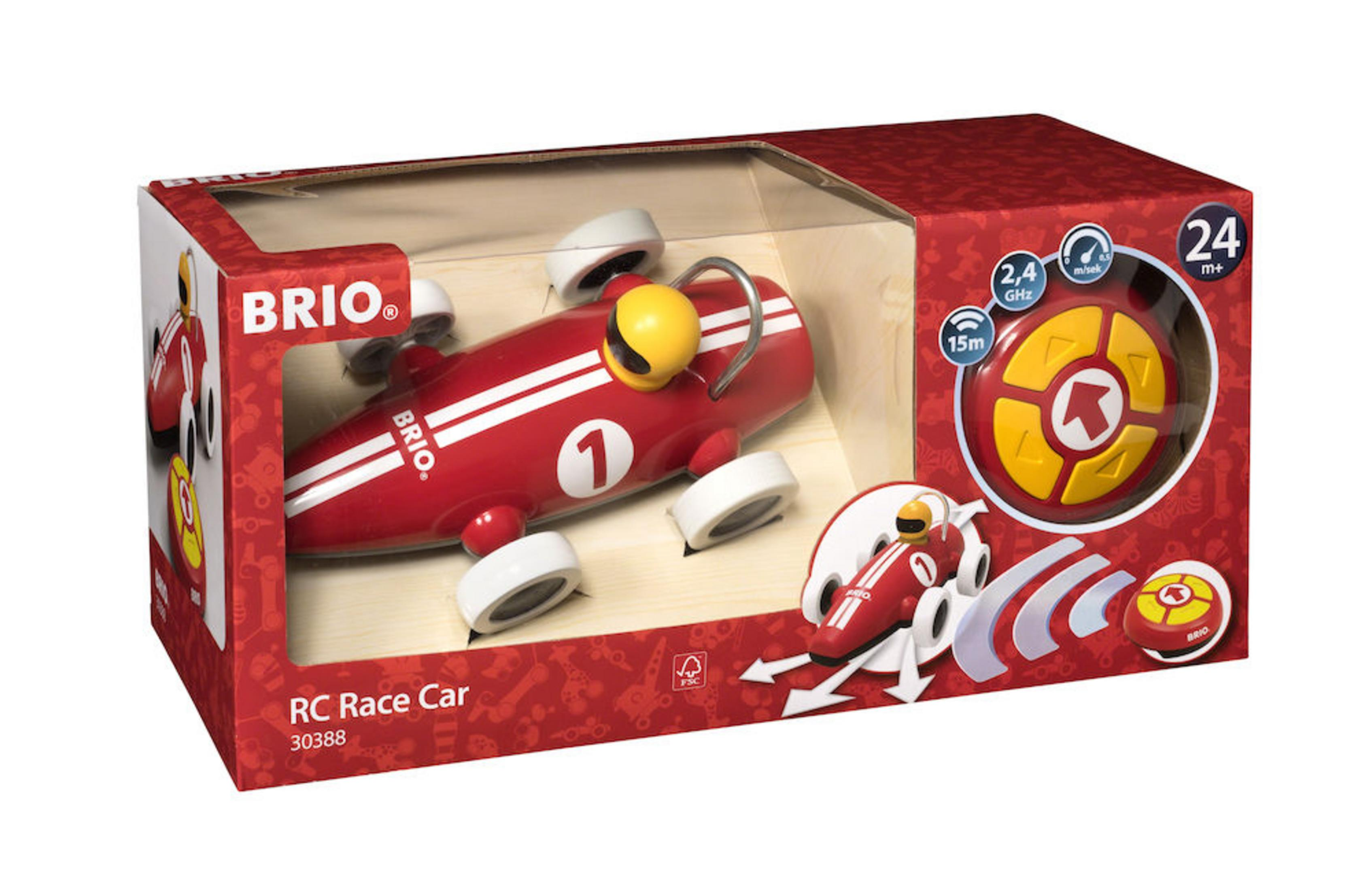 Rotes Spielzeug-Rennauto in einer Box mit Fernbedienung.