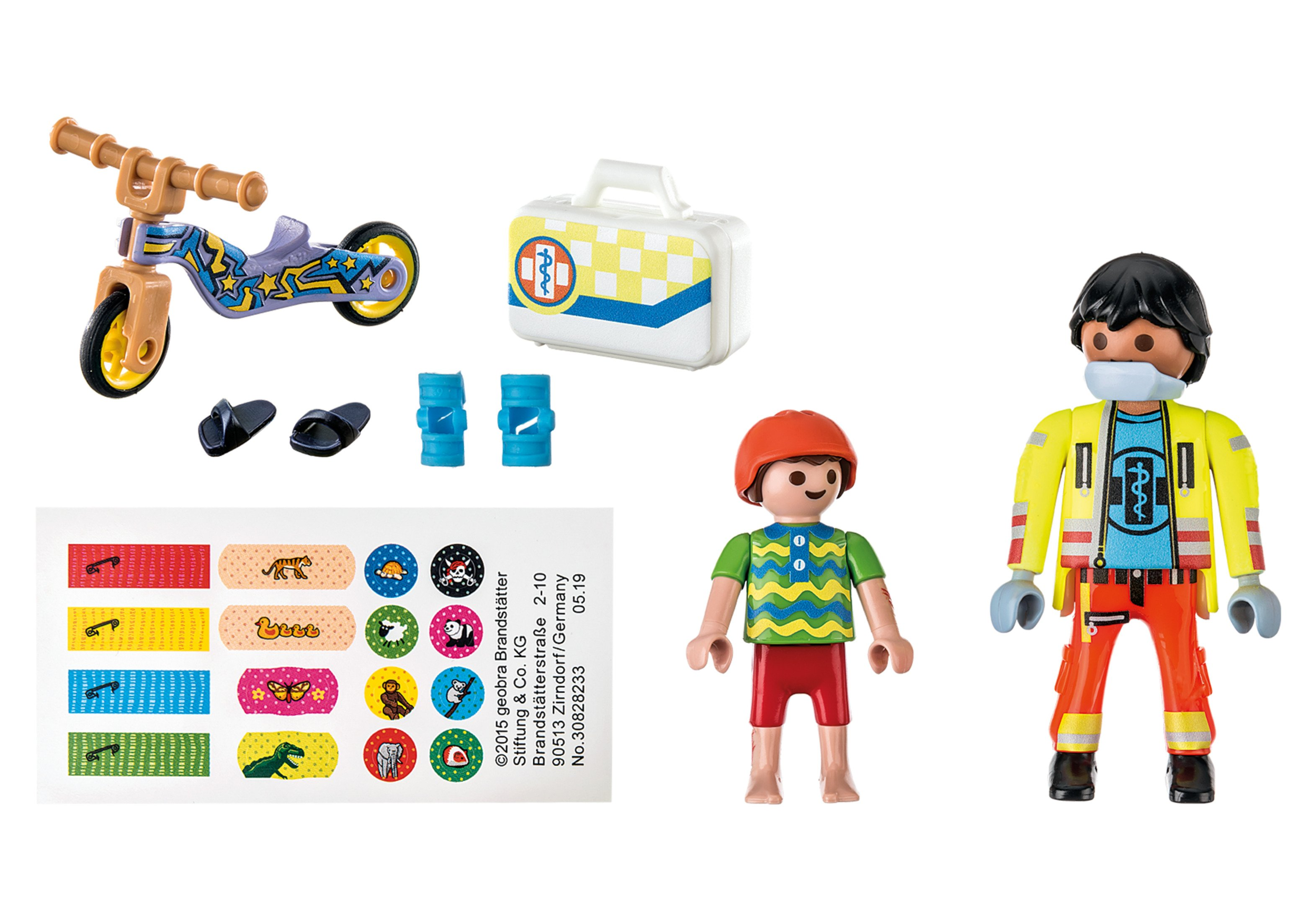 Zabawki Playmobil: rowerek, apteczka, dwie figurki i akcesoria. Białe tło.
