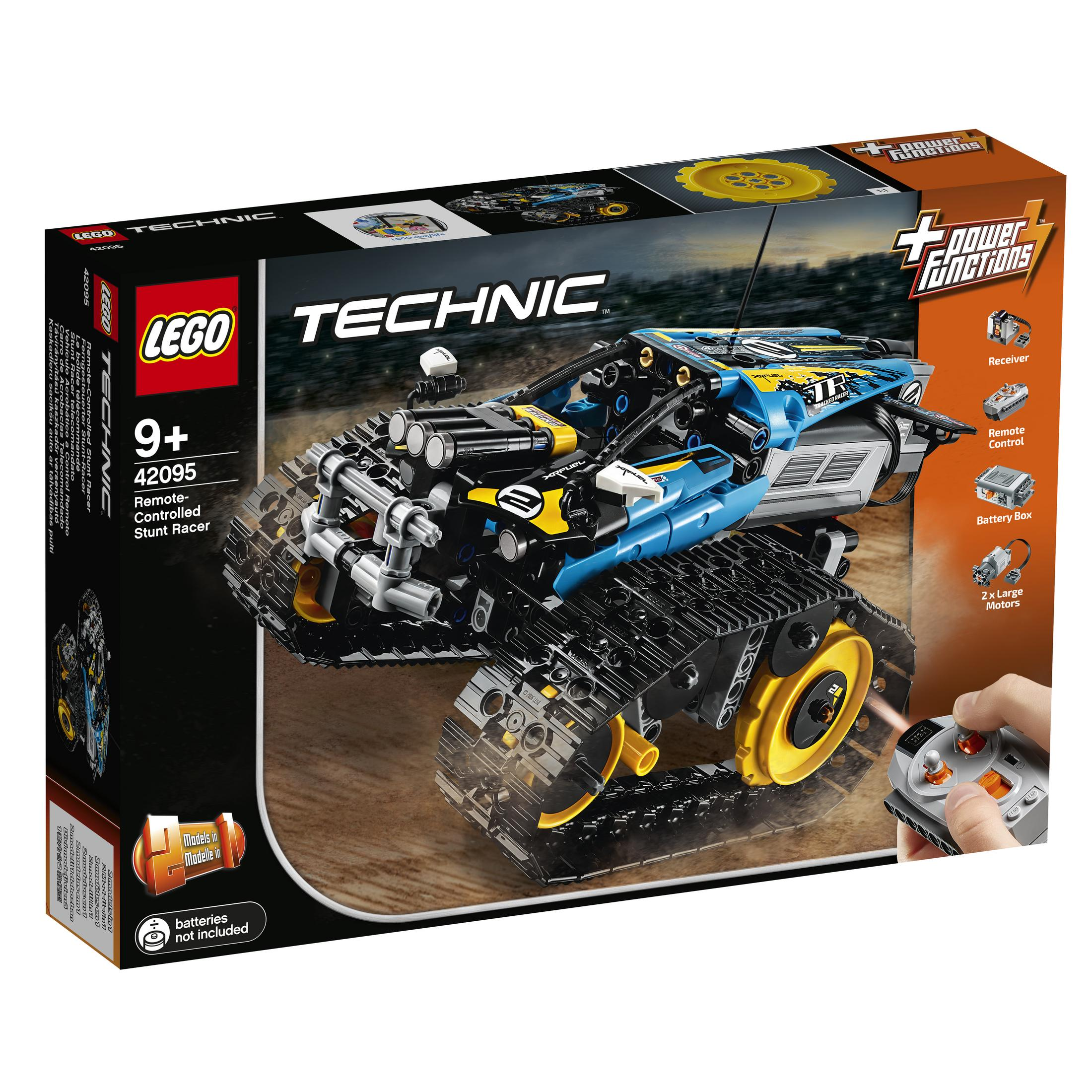 Jouet Lego Technic de cascadeur télécommandé. Il est noir, bleu, jaune et a des chenilles. Le fond est sombre.