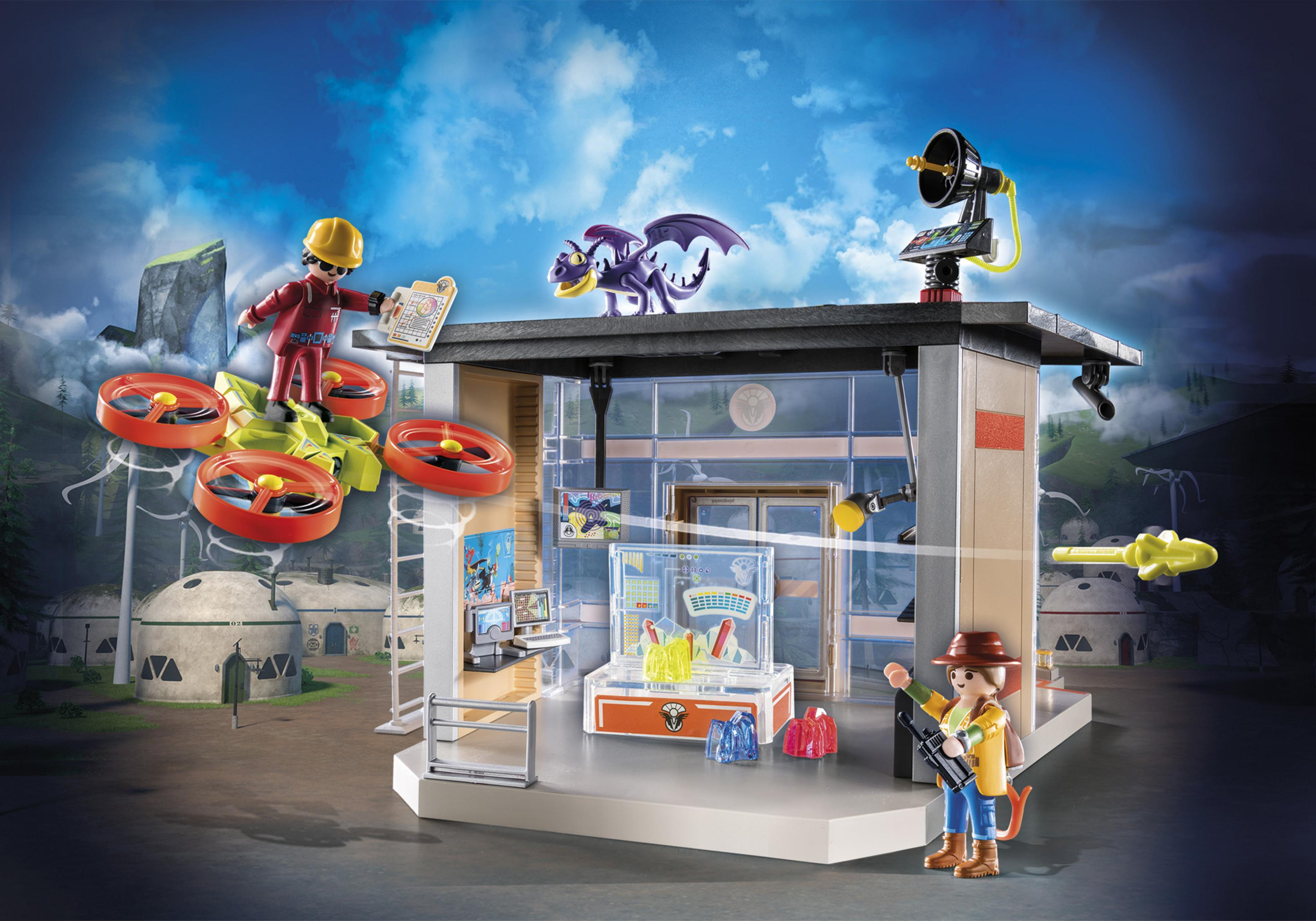 Playmobil set with figures, drones, and a building. The scene is set against a backdrop of a futuristic landscape.