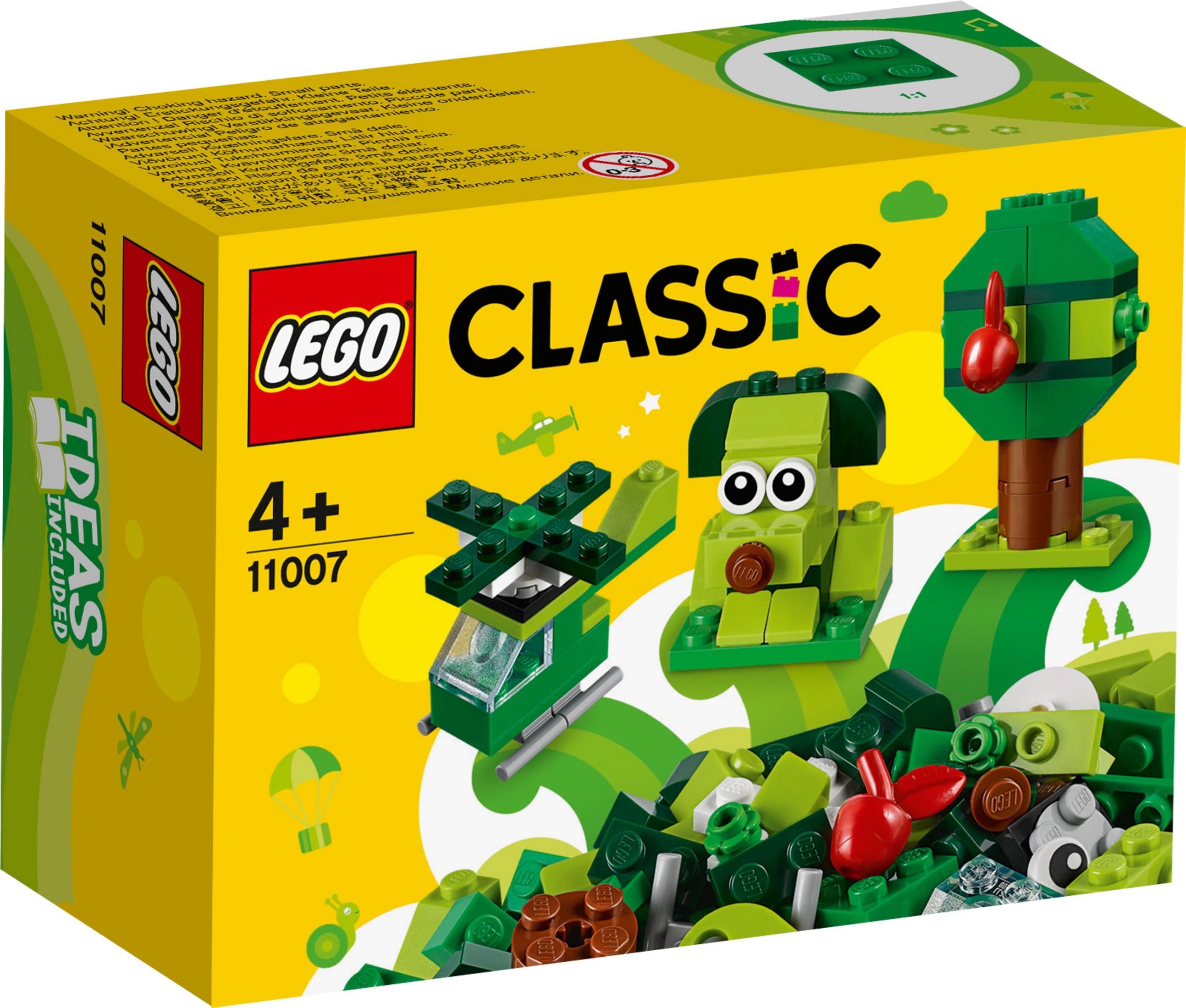 Una scatola Lego Classic con pezzi Lego, tra cui un elicottero, un albero e una struttura simile a un cane.