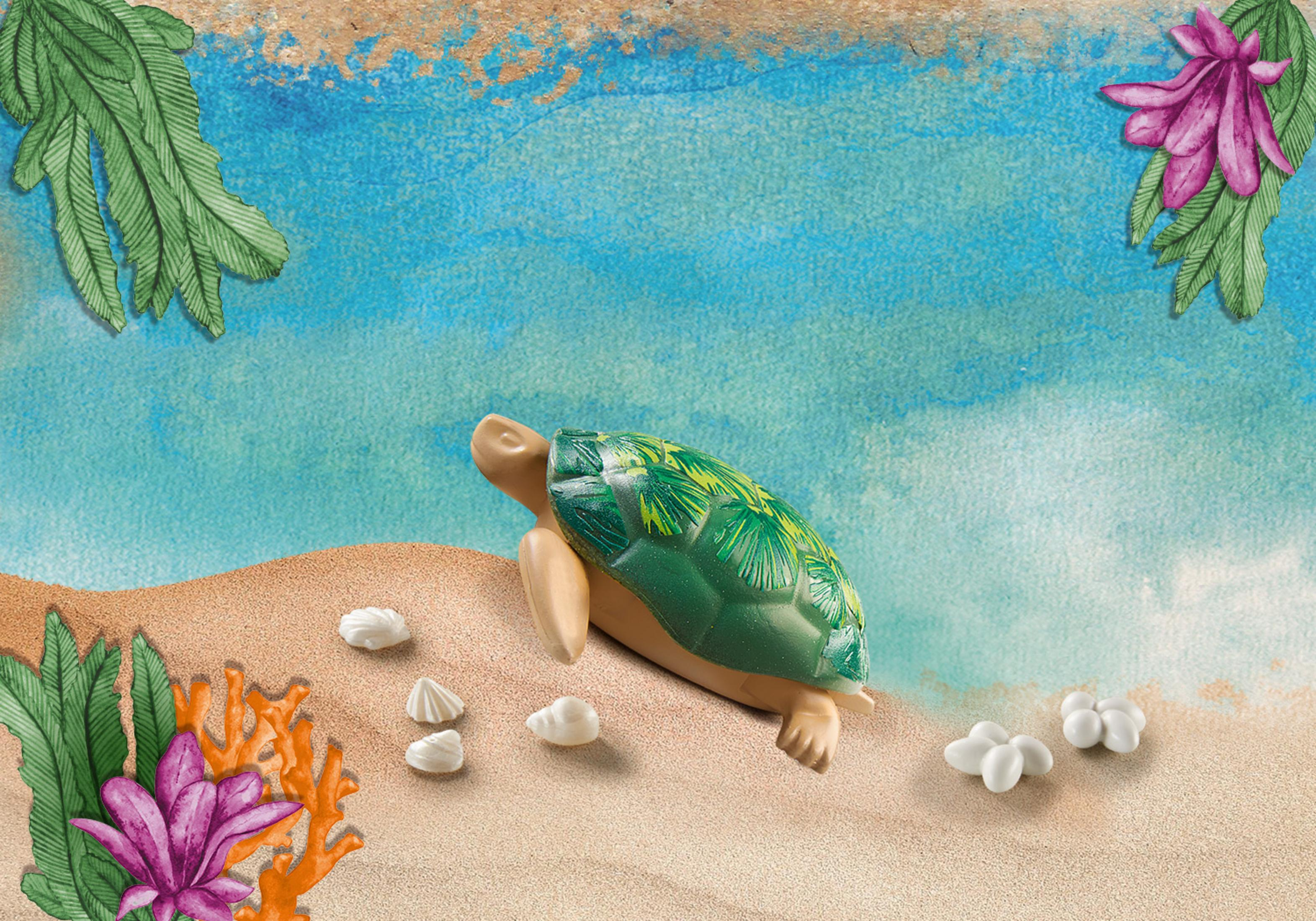 Eine Spielzeugschildkröte an einem Sandstrand mit Muscheln und Pflanzen.