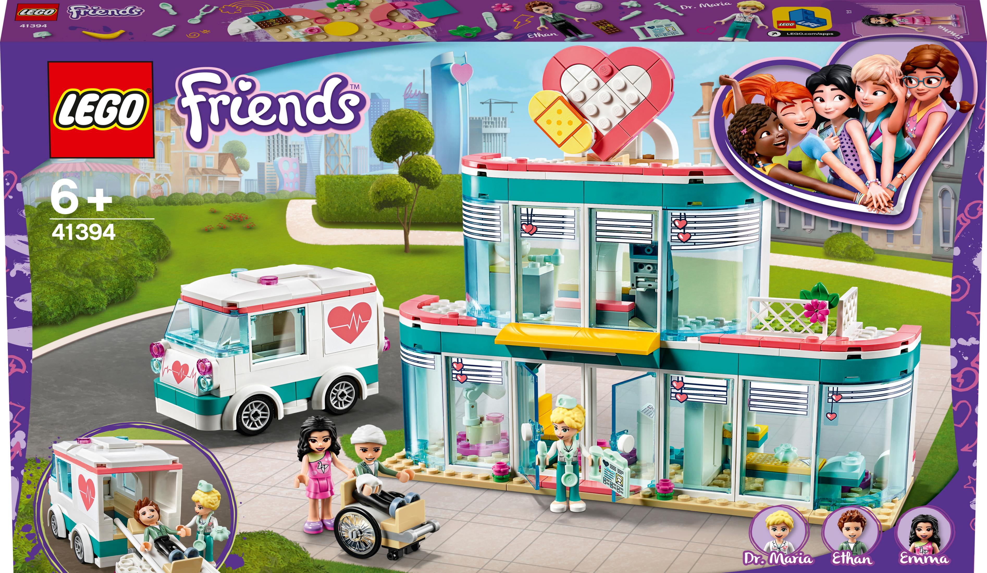 Lego Friends Set. Ein Gebäude mit Herz auf der Oberseite und eine Seite mit Krankenwagen und Figuren.