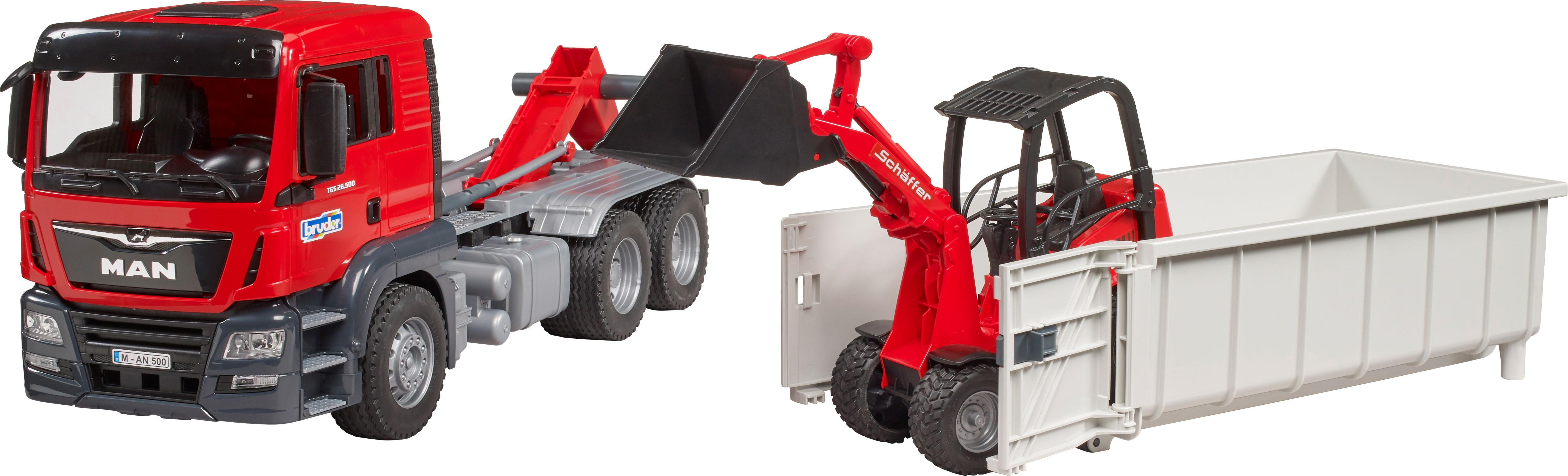 Roter LKW mit schwarzem Eimer, roter Lader, weißer Container.
