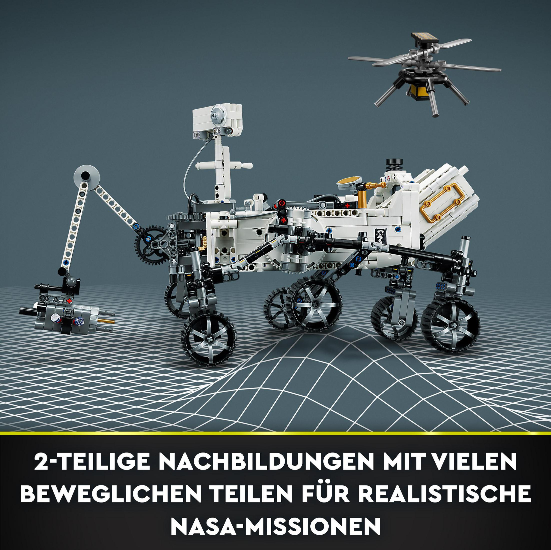 Model łazika marsjańskiego Lego z małym modelem helikoptera w tle. Tekst jest po niemiecku.