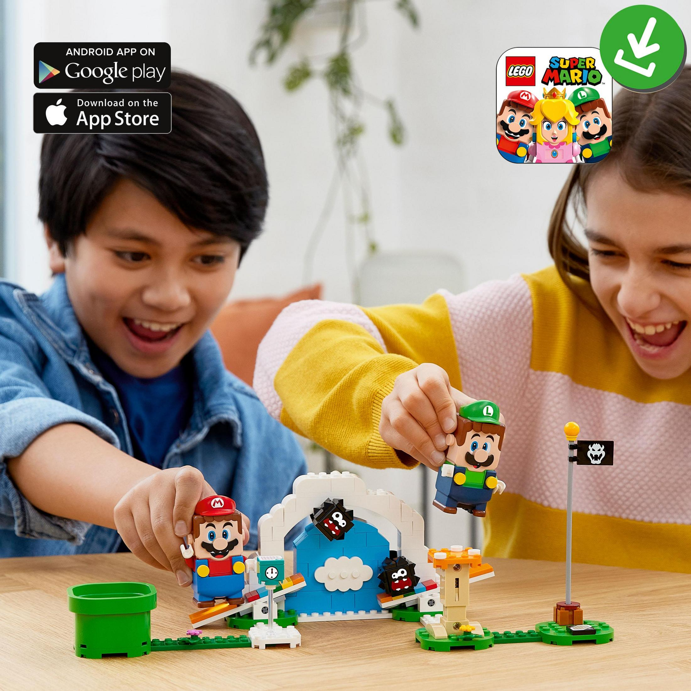 Two kids playing with a Lego Super Mario set. Mario and Luigi figures, with a green pipe.