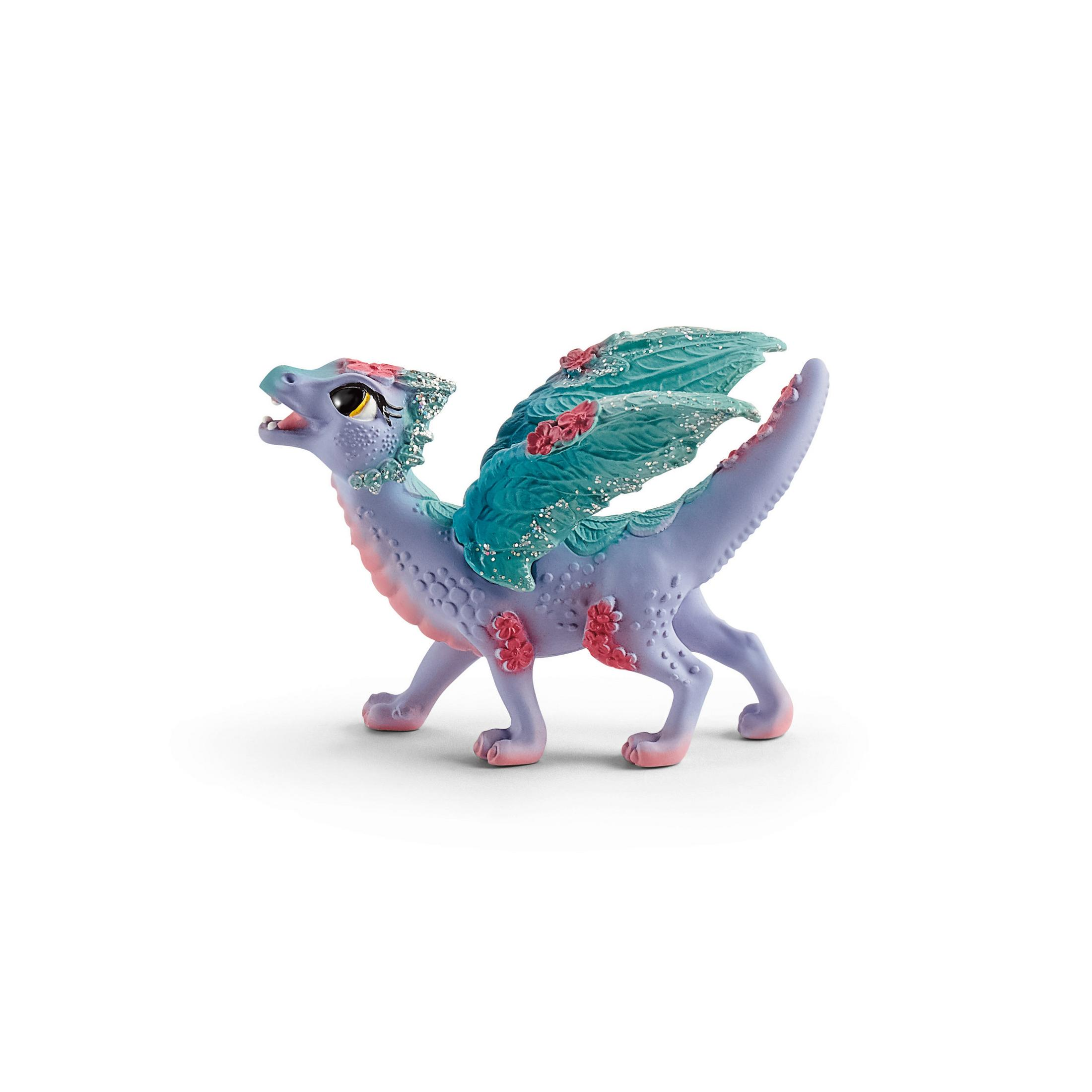 Ein lila Spielzeugdrache mit blauen Flügeln und rosa Akzenten, auf weißem Hintergrund.
