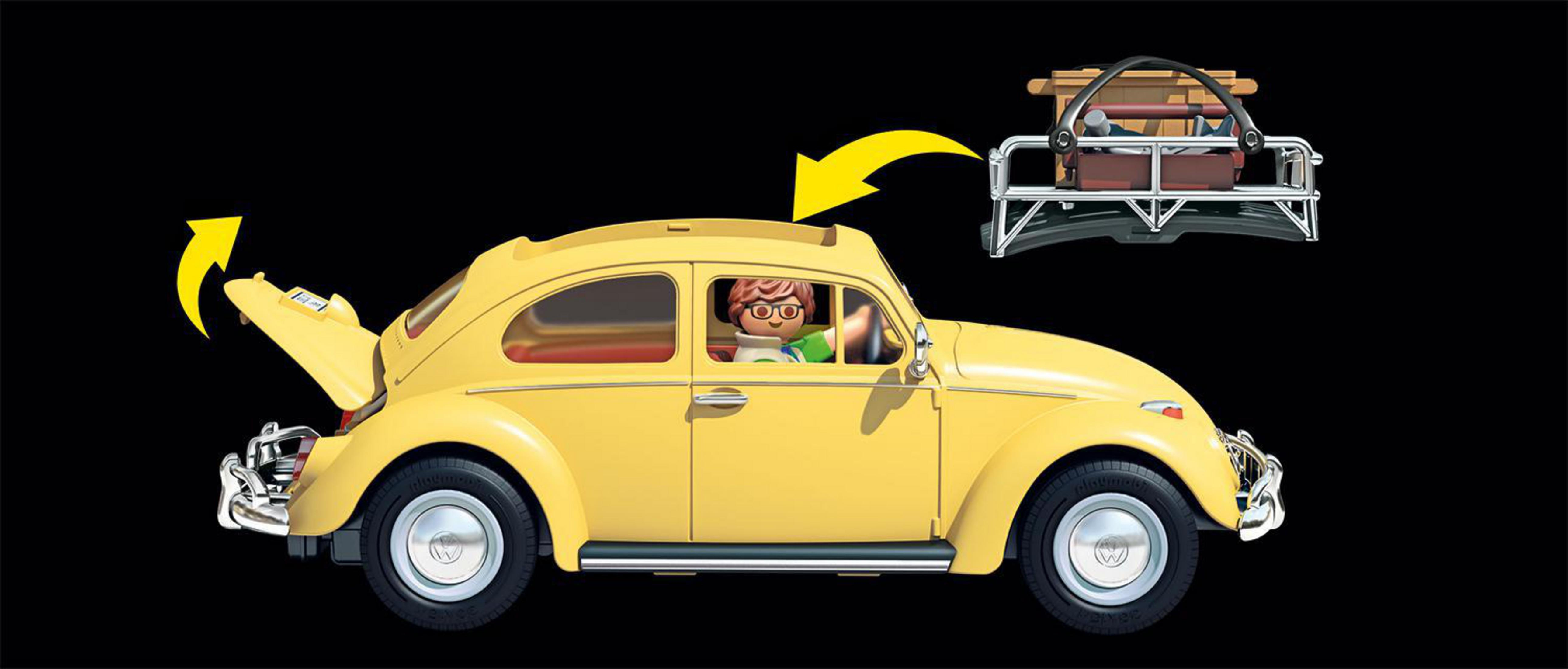 Un'auto gialla d'epoca, con il bagagliaio e il portapacchi aperti, su sfondo nero.