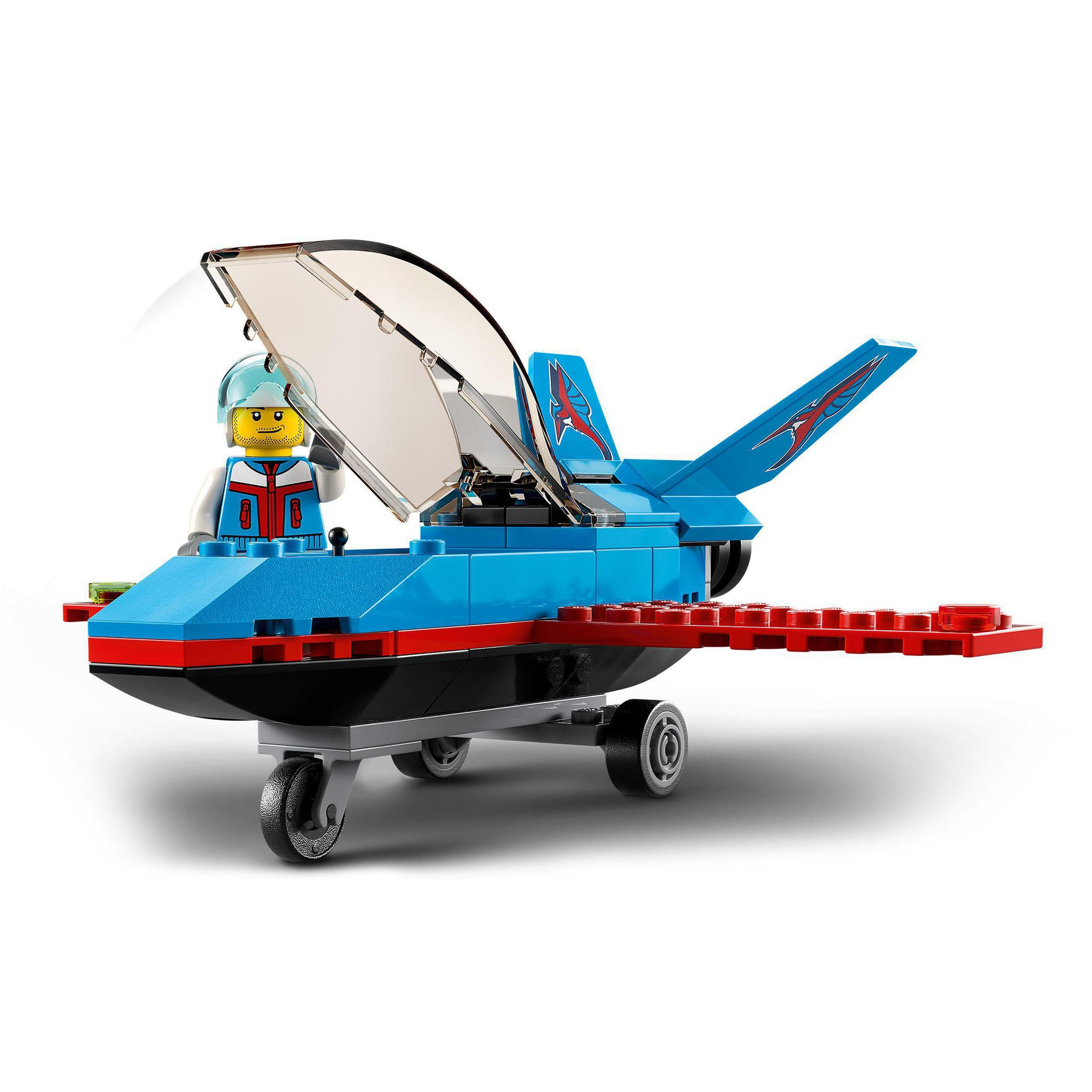 Ein blau-rotes Lego-Flugzeug mit einem Piloten in weißer Uniform. Es hat ein transparentes Cockpit.