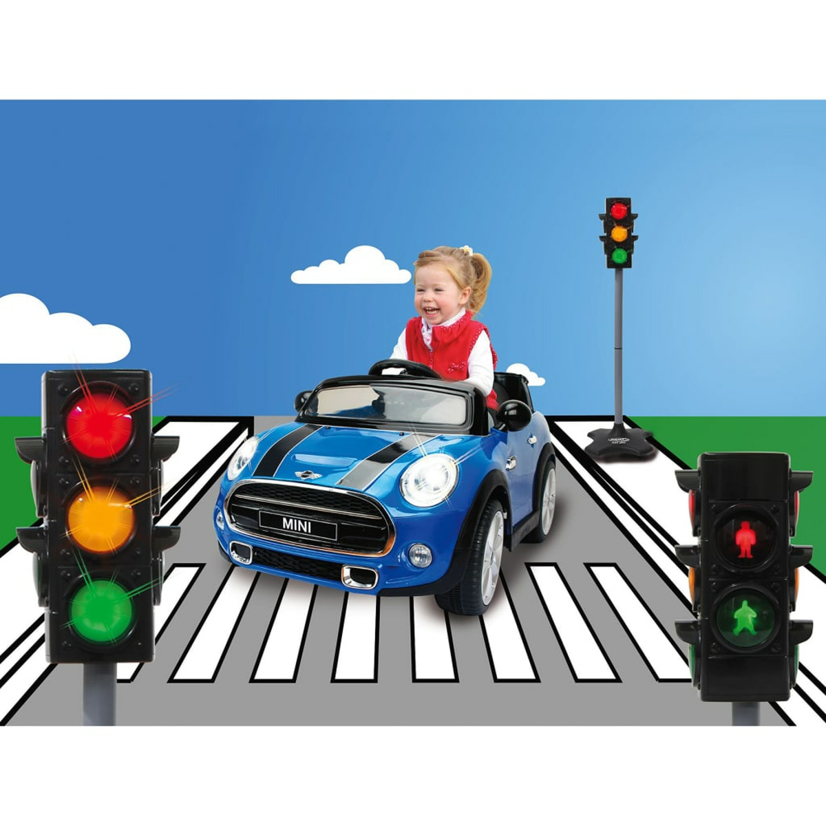 Dziewczynka prowadzi niebieski samochodzik na pasach z zabawkami sygnalizatorami świetlnymi.
