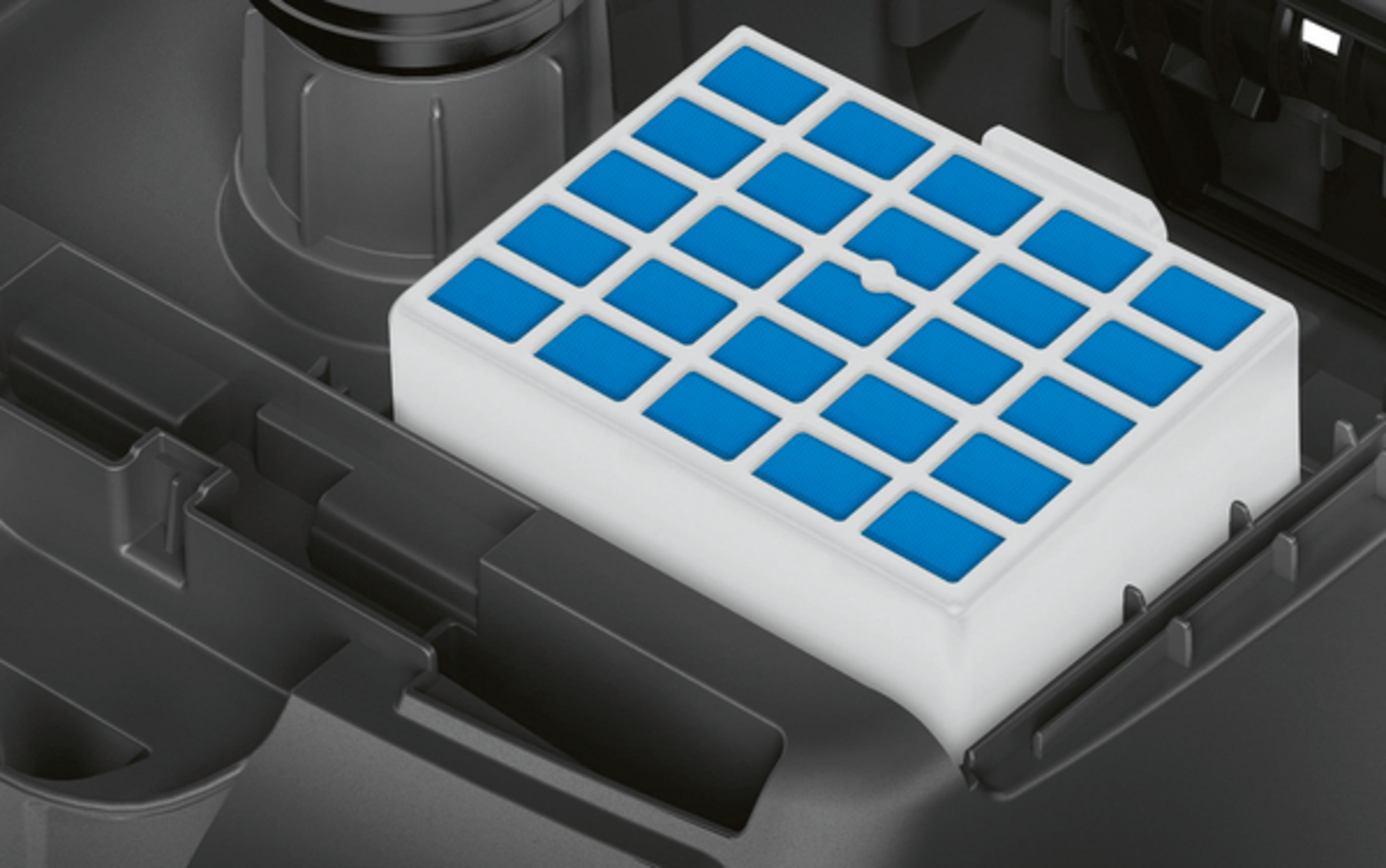 Biały i niebieski filtr wewnątrz ciemnoszarej maszyny, zbliżenie.