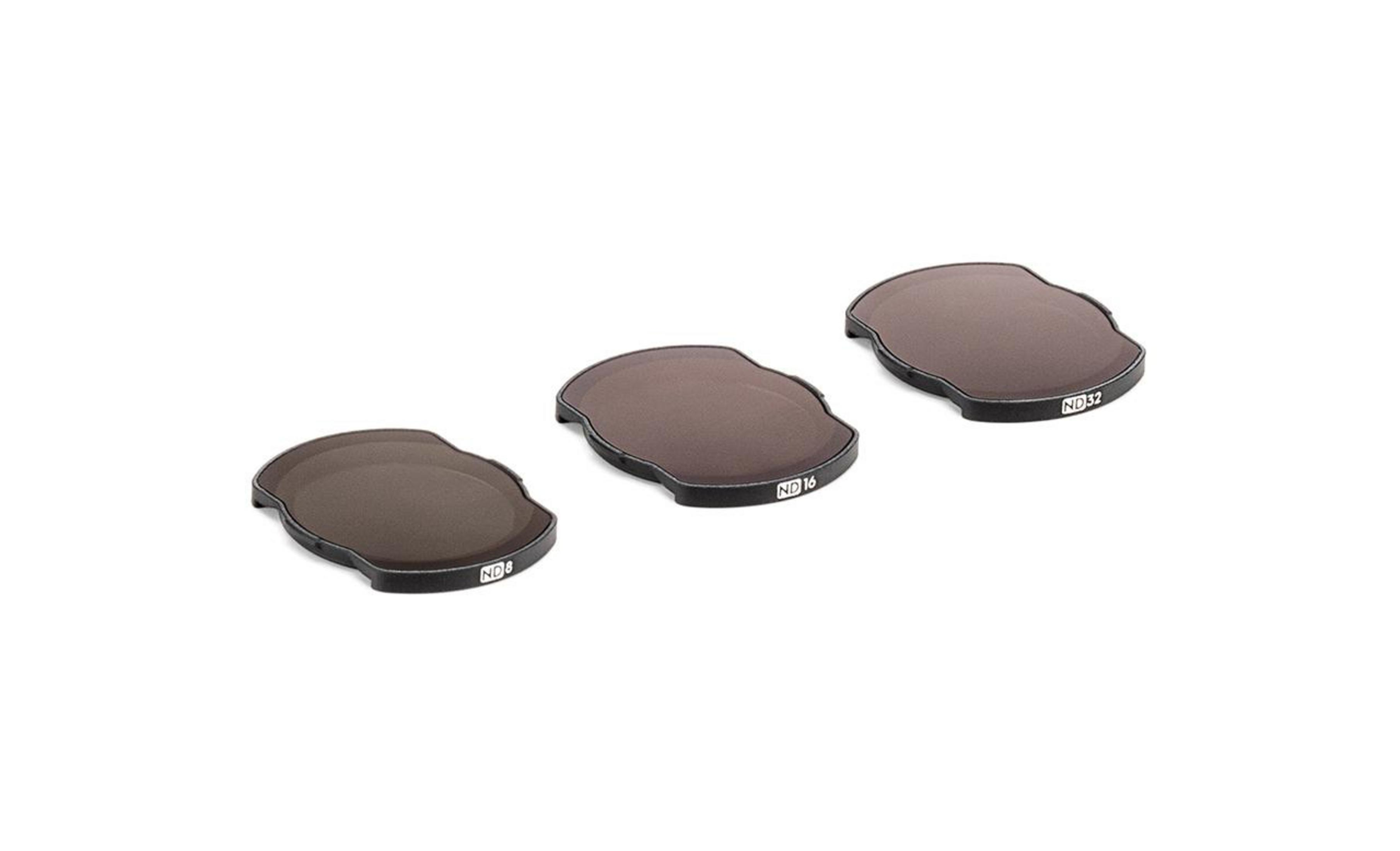 Tres filtros de cámara de densidad neutra en una fila, cada uno con un marco negro.