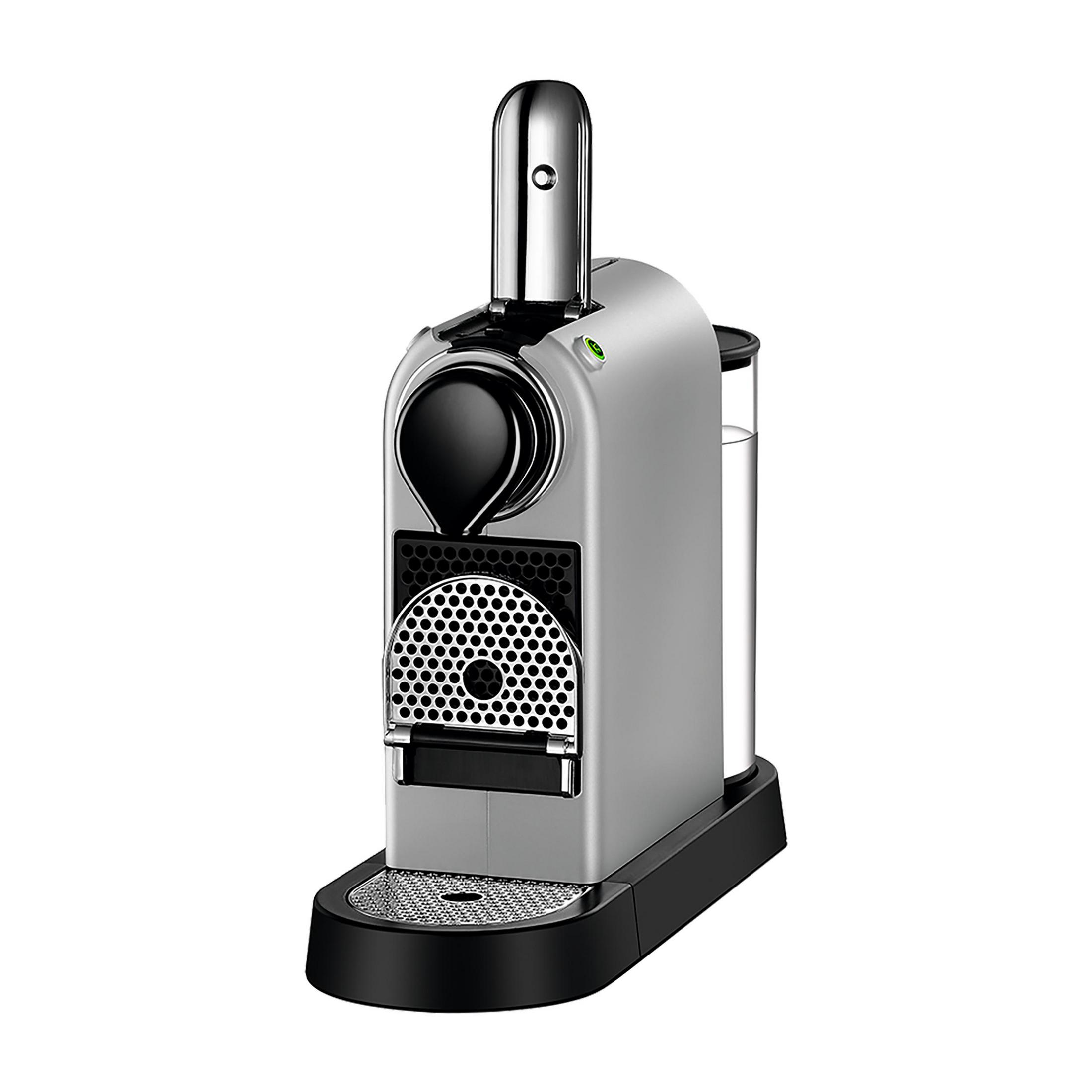 Srebrny ekspres do kawy Nespresso na czarnej podstawie. Posiada zbiornik na wodę i metalową kratkę.