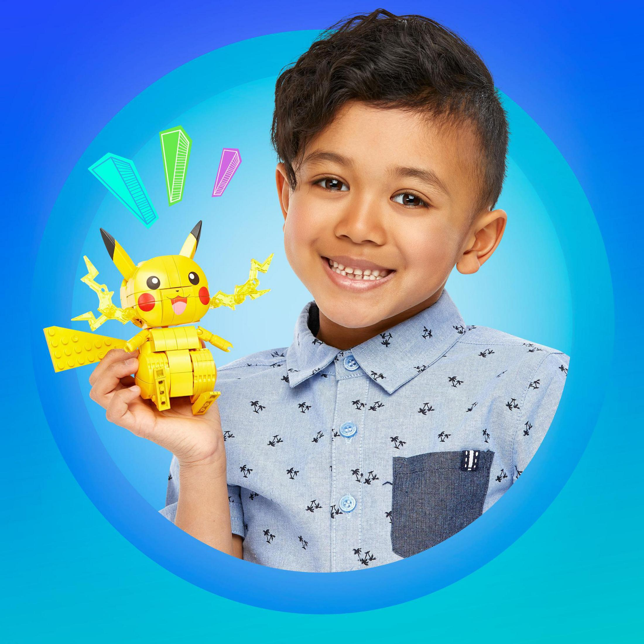 A boy holds a Pikachu Lego figure. Blue circle background with colorful graphic elements.