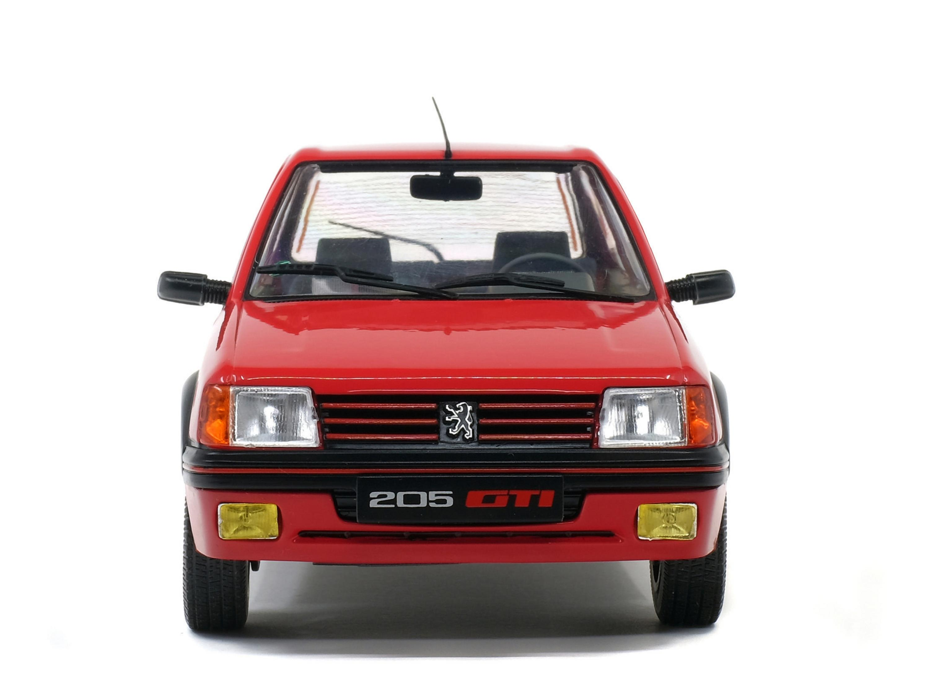 Un'auto Peugeot 205 GTI rossa su sfondo bianco. L'auto è vista frontalmente.