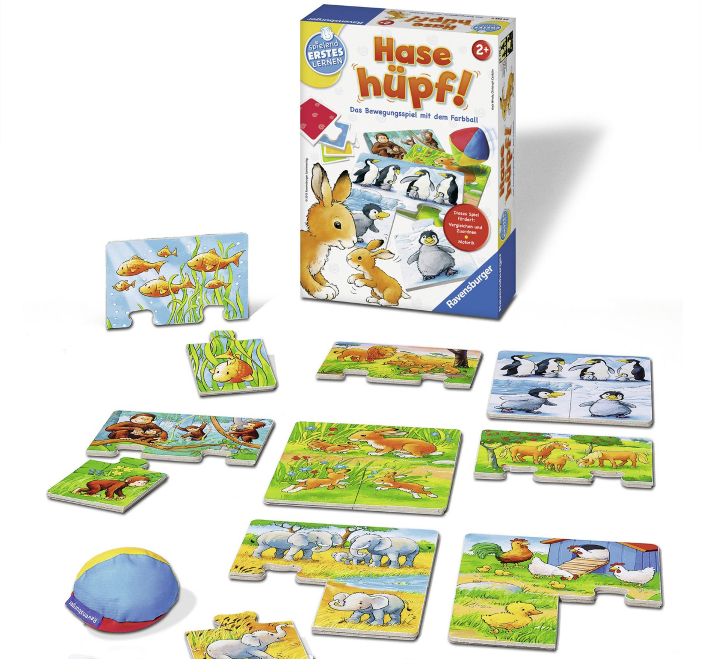 Ein Brettspiel mit Puzzleteilen. Ein Hase und Pinguine sind abgebildet.