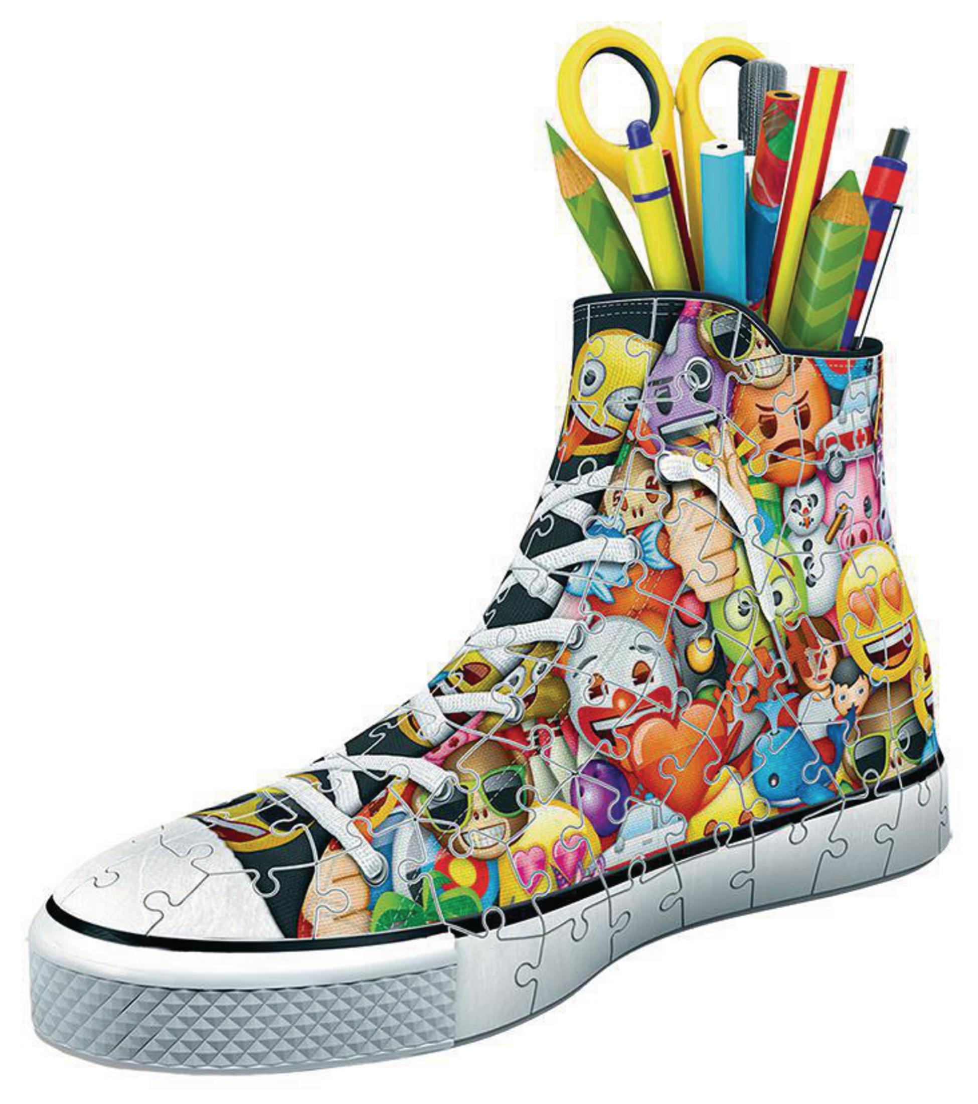 Puzzle w kształcie buta, wypełnione emotikonami i ołówkami.