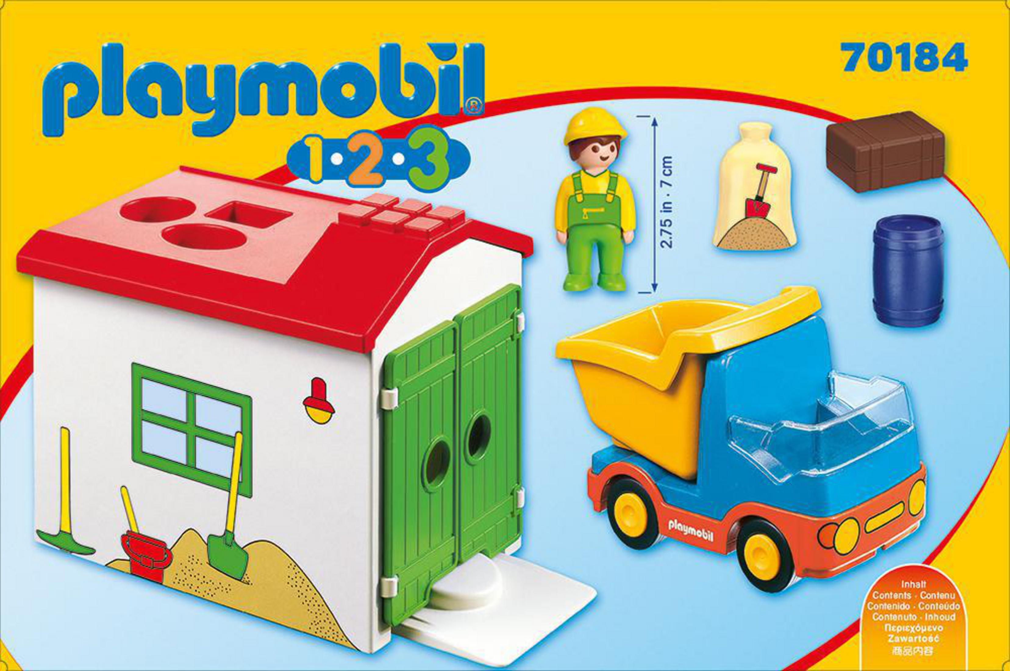 Ein Playmobil-Spielset mit Haus, LKW, Bauarbeiter und Zubehör.