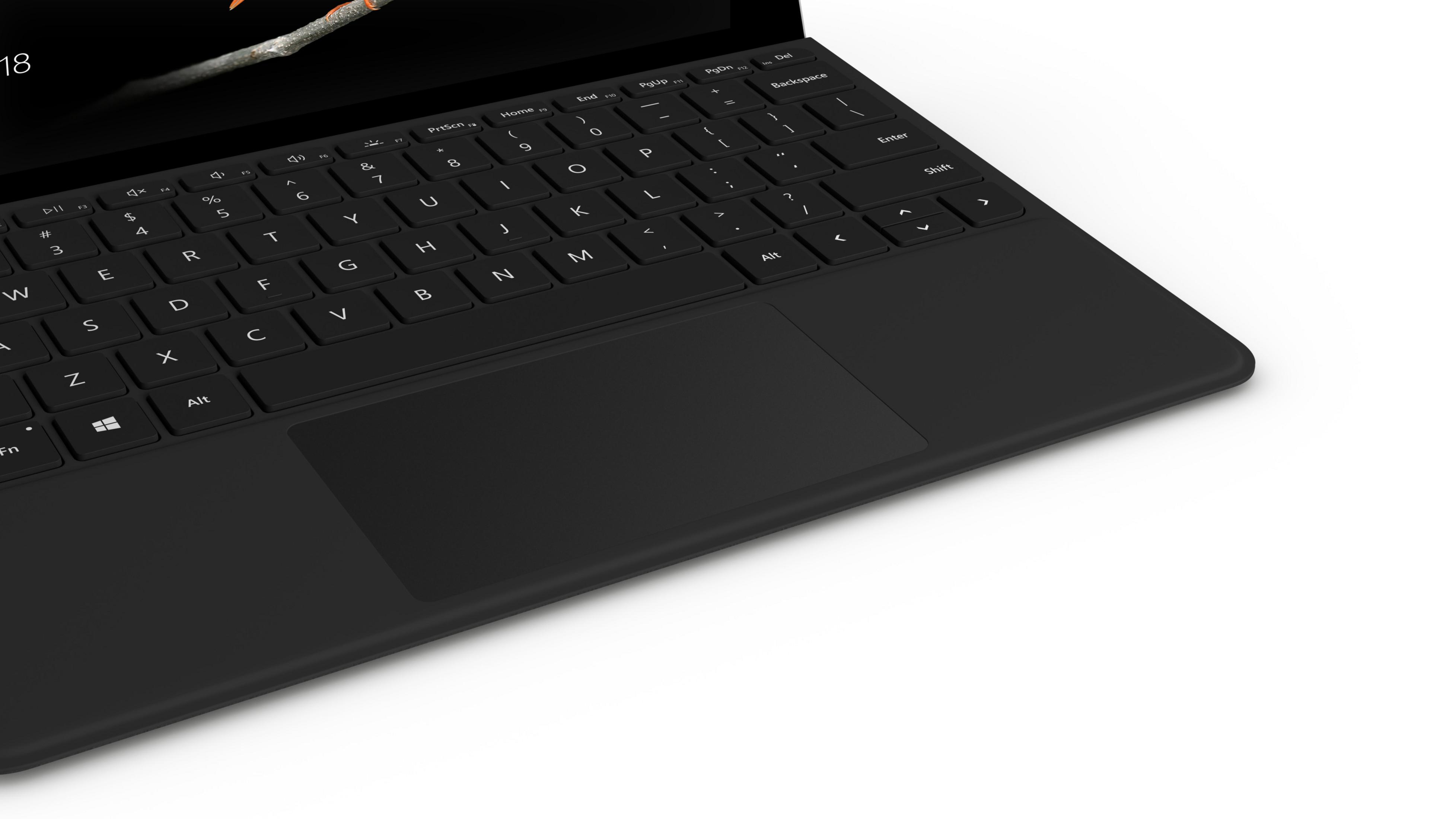 Schwarze Tastatur und Trackpad auf weißer Oberfläche, obere rechte Ansicht.