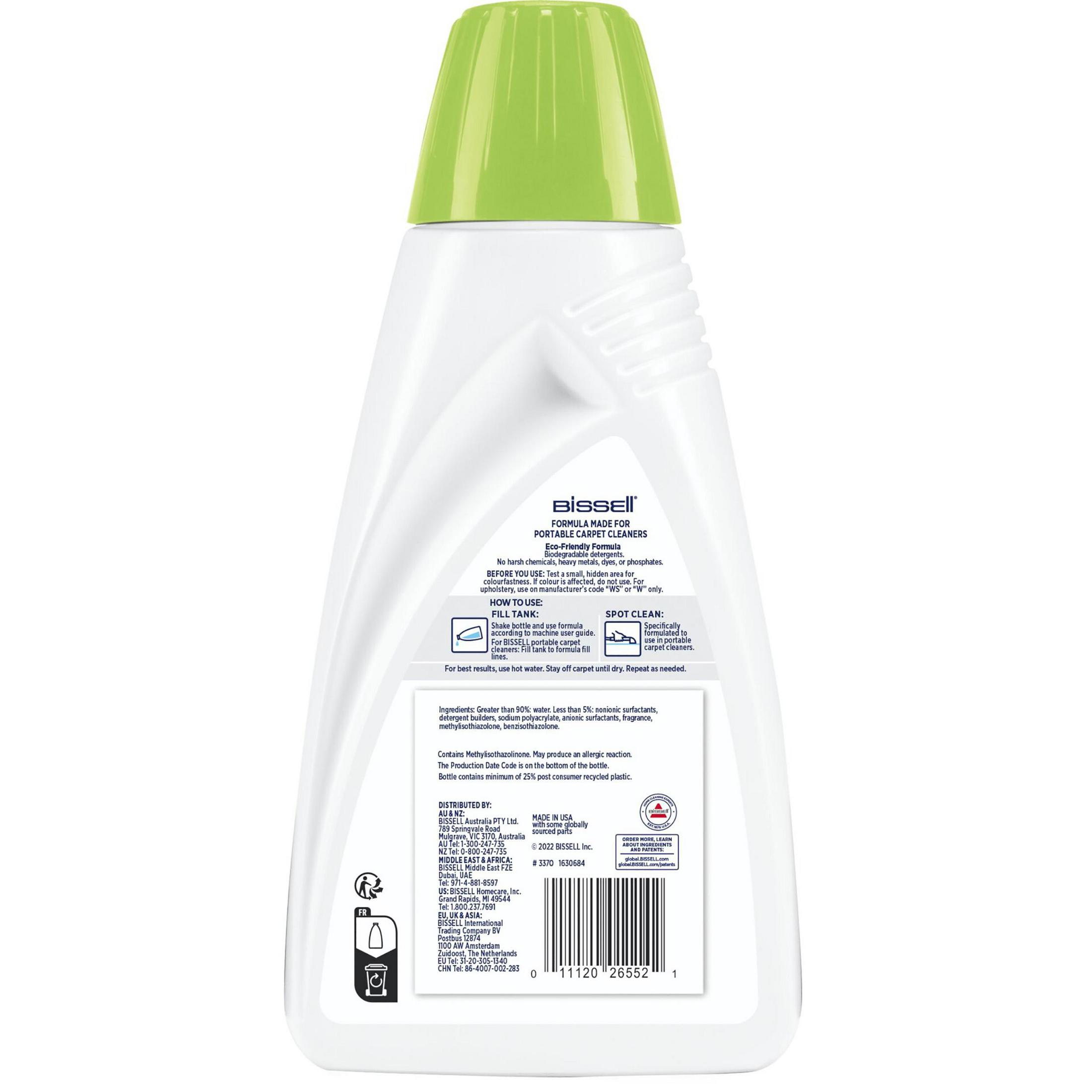Flacone bianco di detergente per tappeti portatile Bissell con tappo verde.