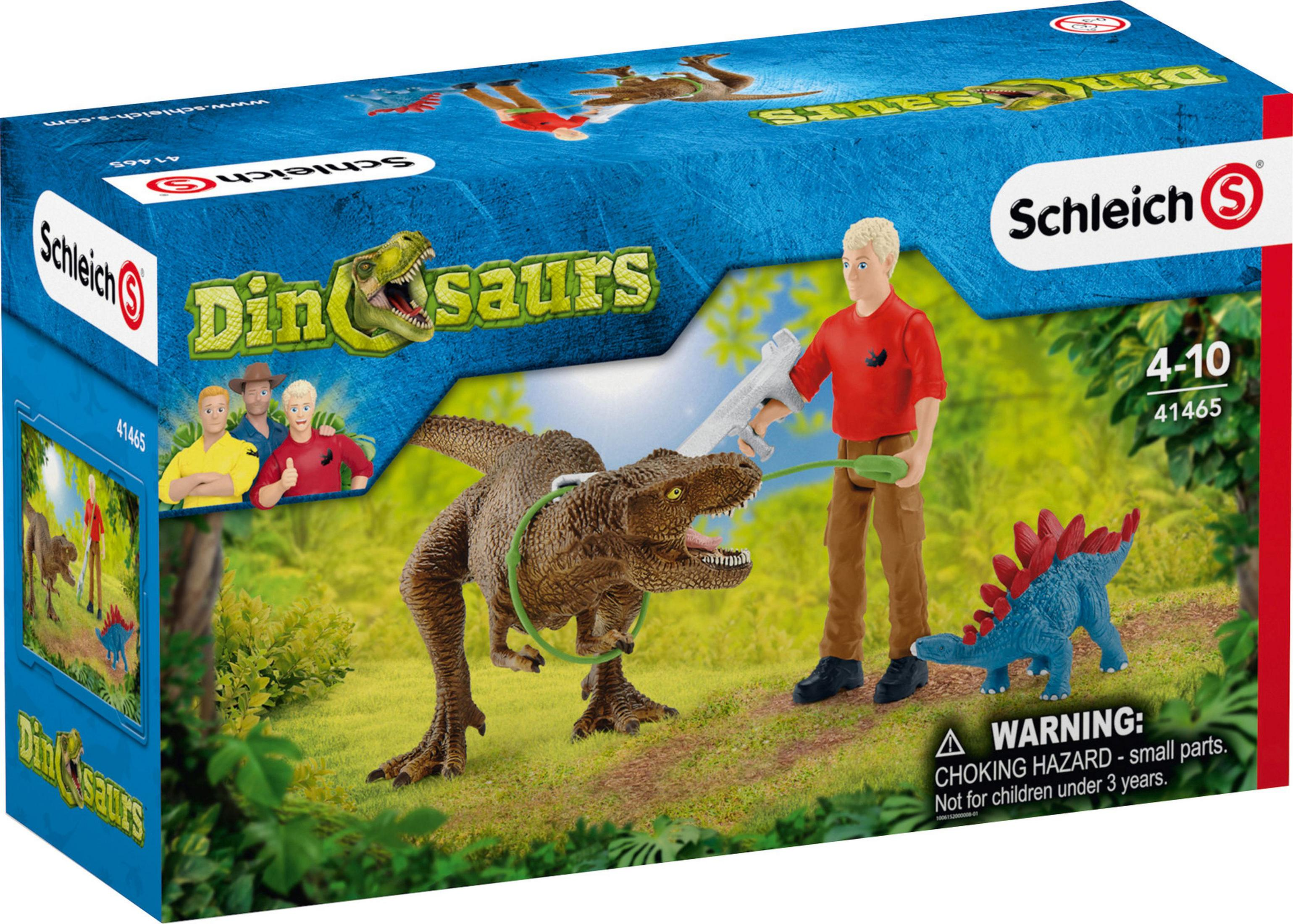 Box-Set: Tyrannosaurus Rex, Mann mit Waffe, Stegosaurus und eine Kulisse aus Bäumen. Dinosaurierfiguren.