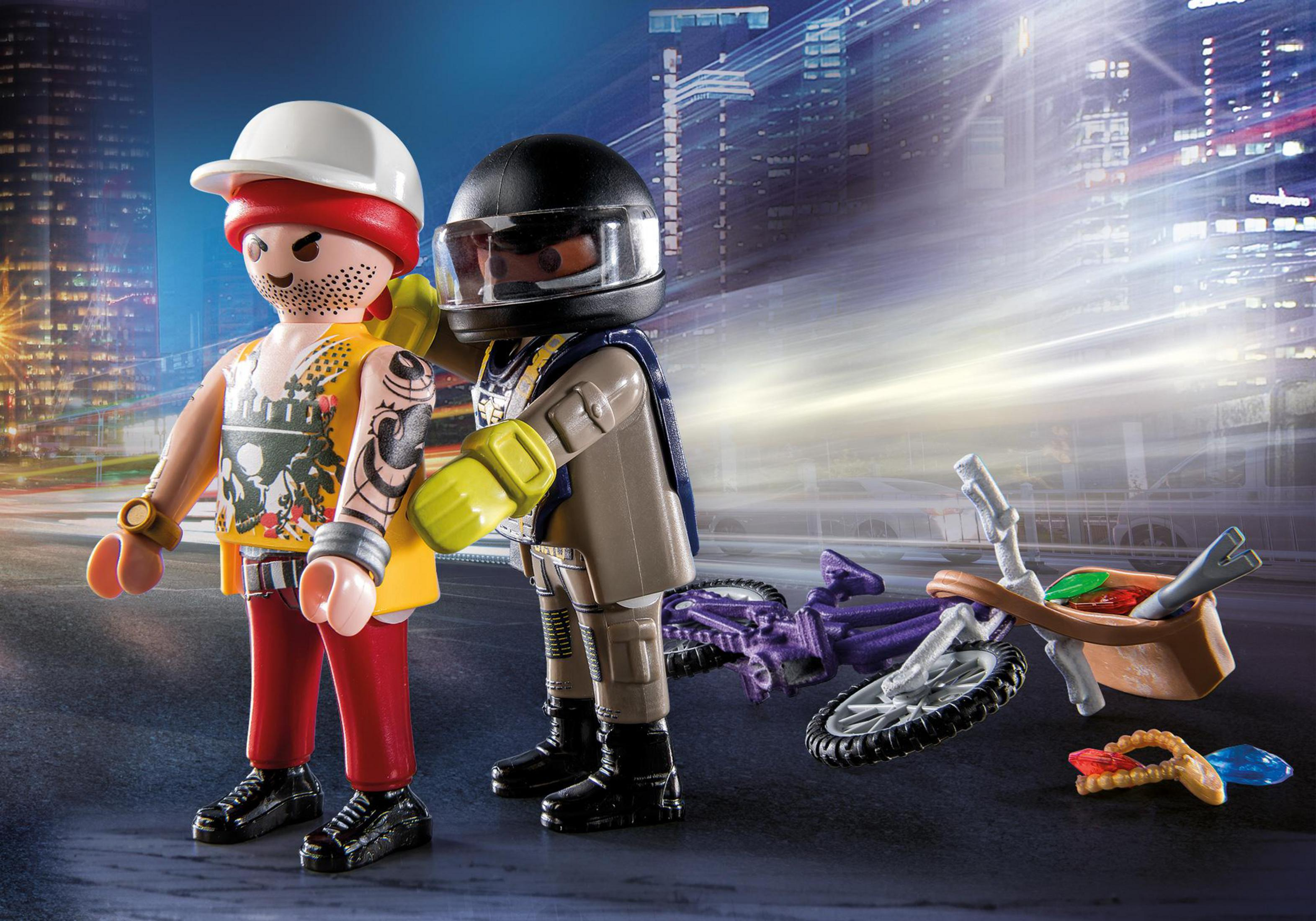 Zwei Playmobil-Figuren in einer Straßenszene mit Motorrad.
