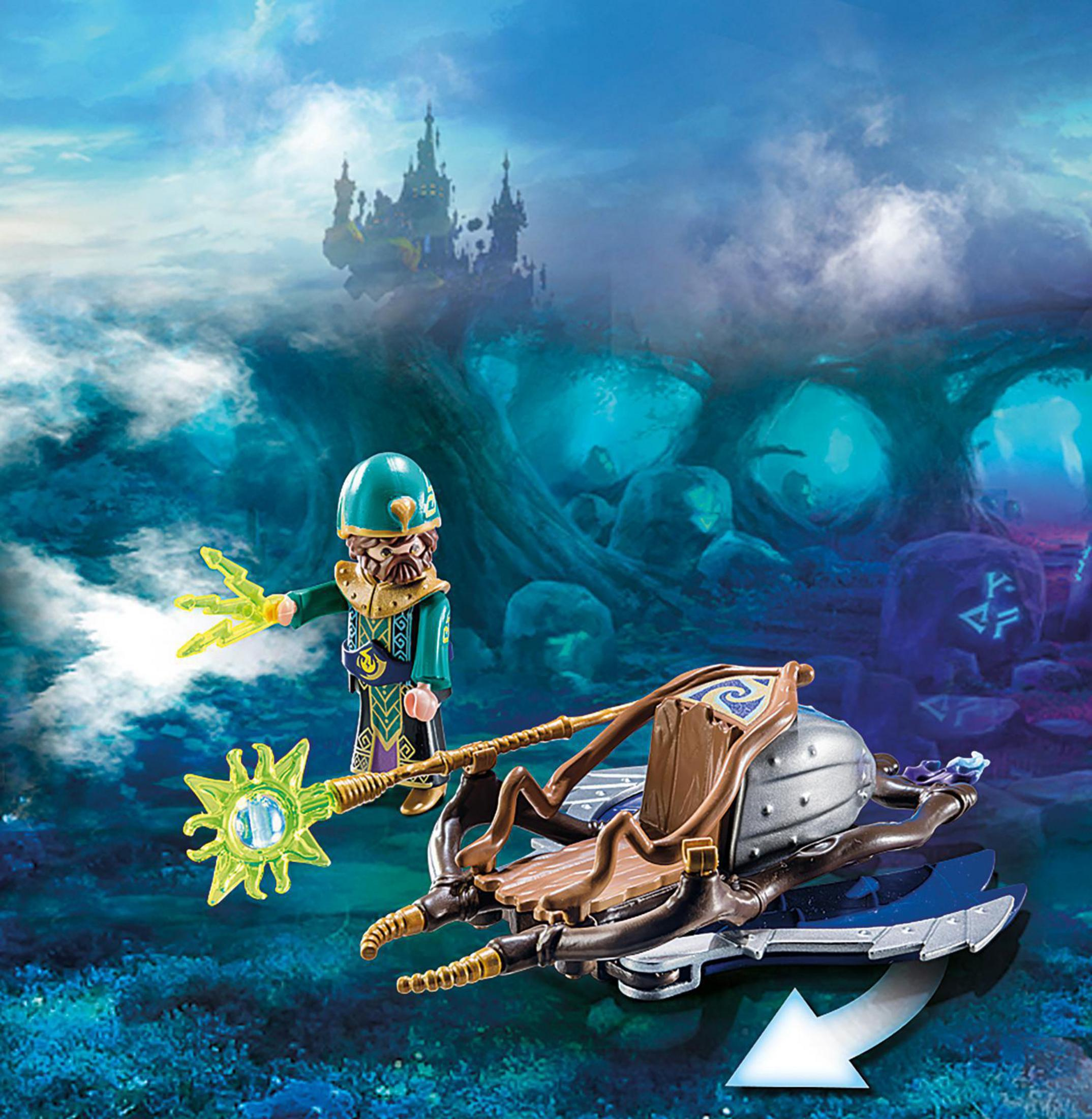 Un giocattolo mago con una scena fantasy. Il mago tiene in mano un bastone luminoso. Un veicolo è al centro.