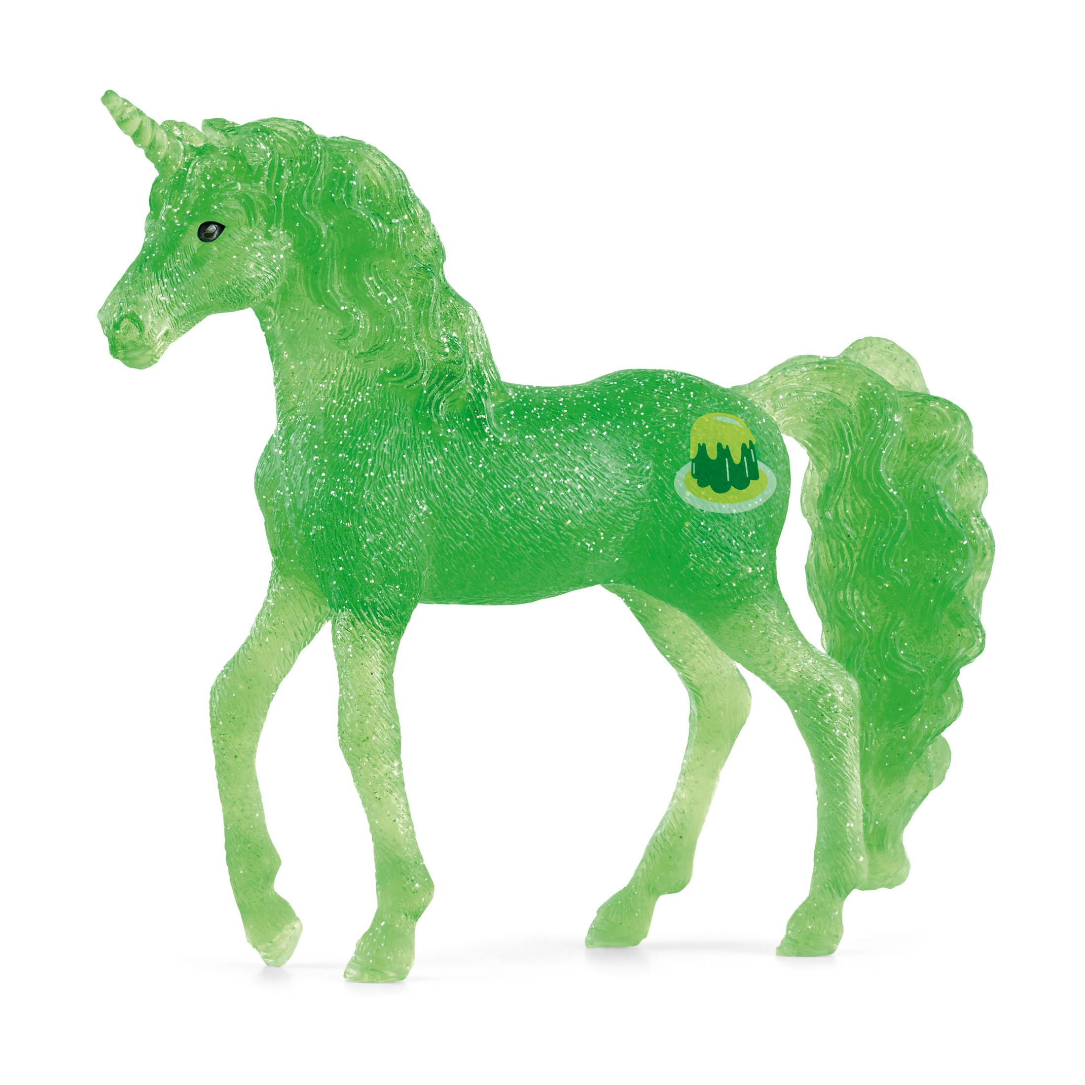 Grünes, glitzerndes Einhornspielzeug mit Horn. Hat ein Logo an der Seite. Das Einhorn steht auf weißem Untergrund.