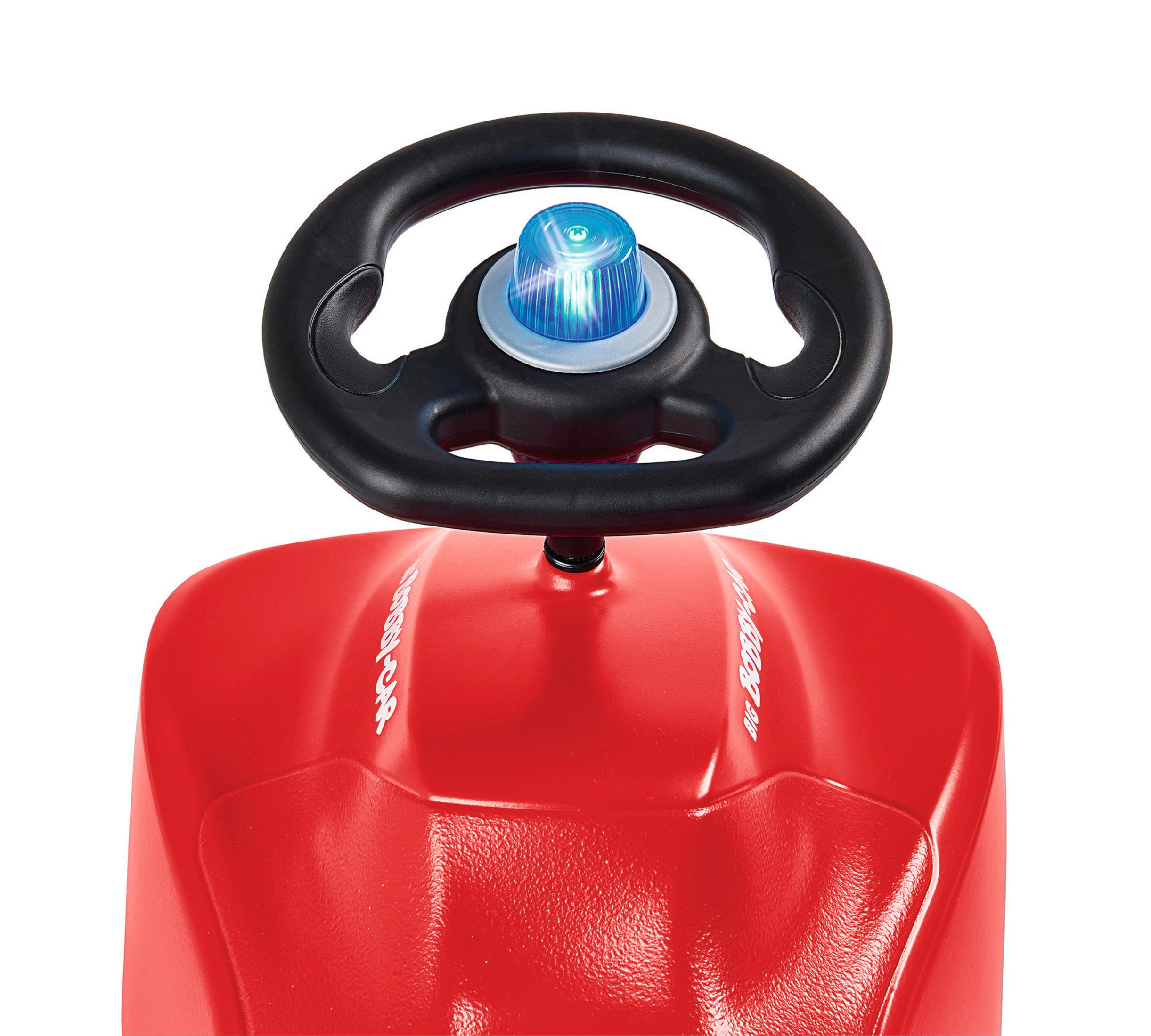 Ein rotes Spielzeugauto mit einem schwarzen Lenkrad und einem blinkenden blauen Licht oben drauf.